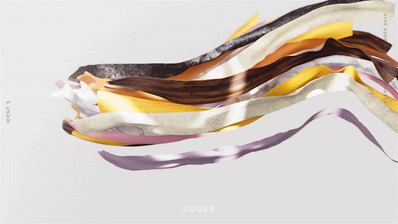 Colorful, wavy ribbons of fabric or paper in shades of white, yellow, orange, pink, purple, brown, and black arranged horizontally against a plain background.