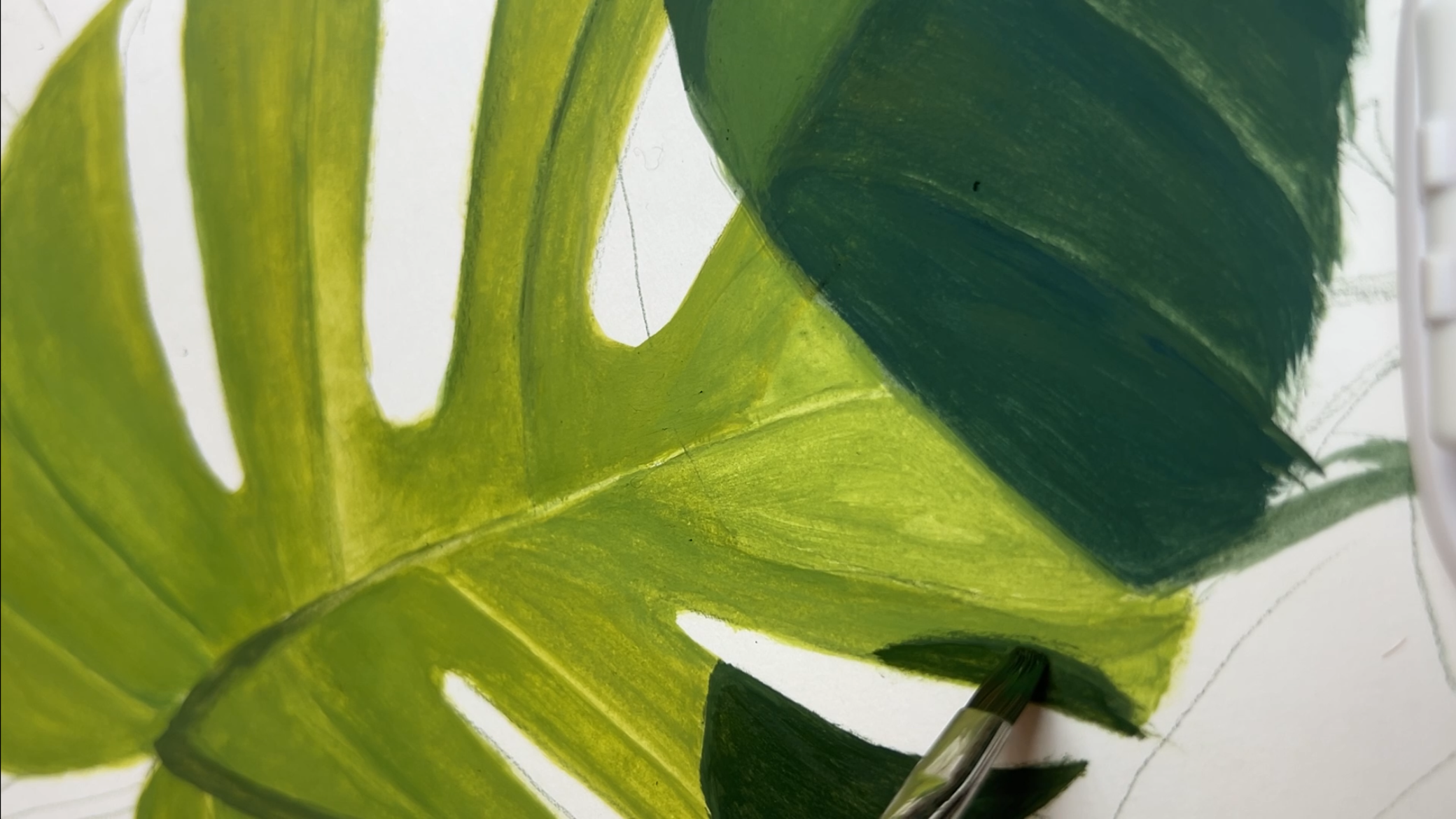 Close-up view of painted green leaves with highlights and shadows.