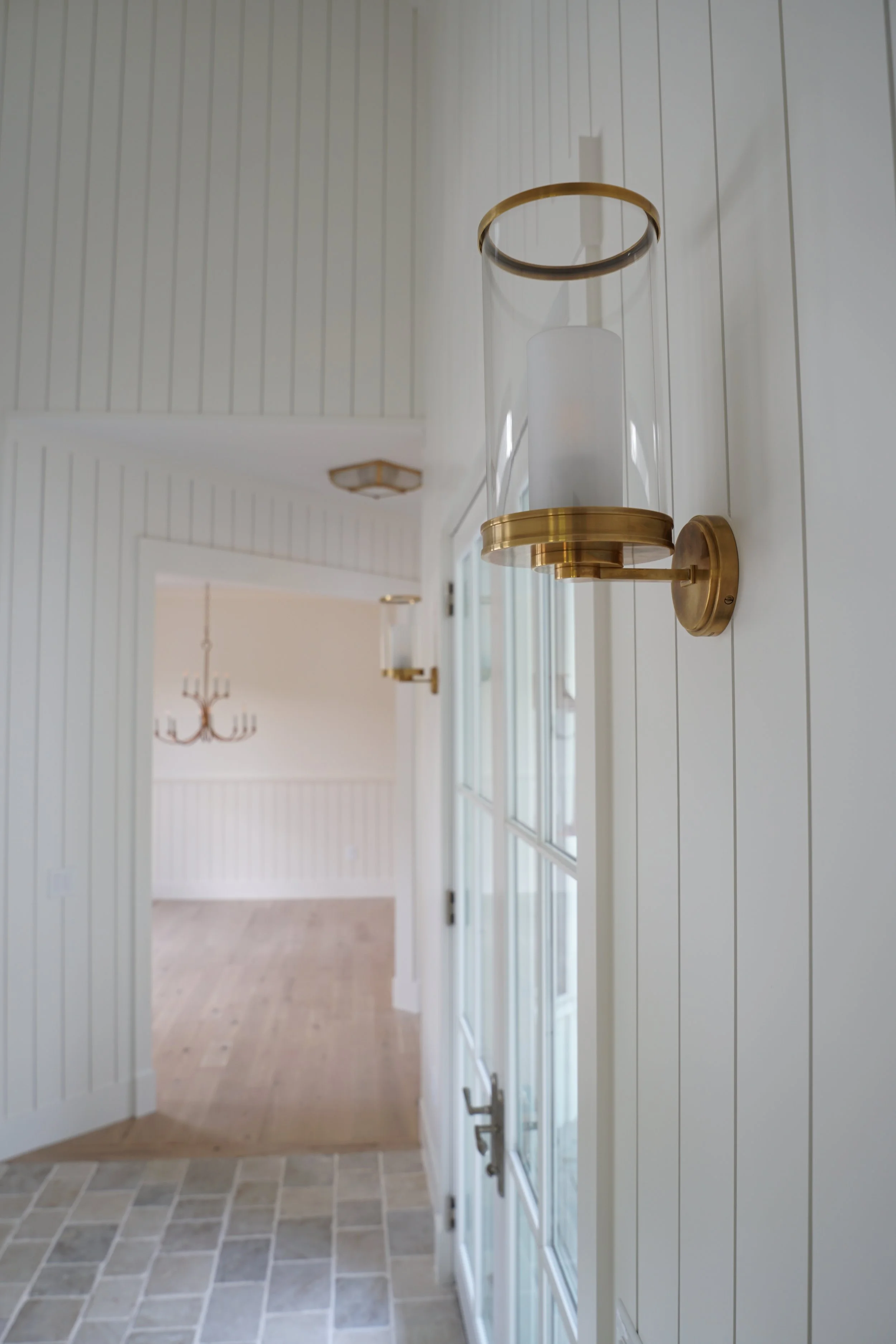 Luxury Rhode Island coastal home by Spinazzola Interiors featuring European farmhouse architecture, custom millwork and timeless coastal interiors.