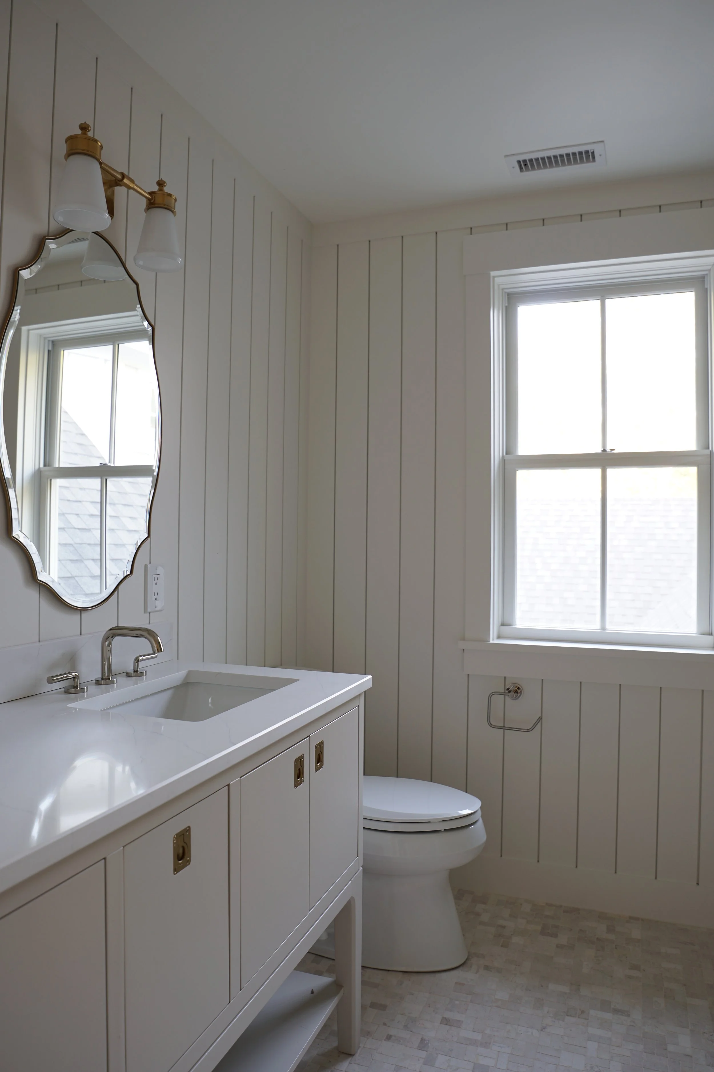 Luxury Rhode Island coastal home by Spinazzola Interiors featuring European farmhouse architecture, custom millwork and timeless coastal interiors.