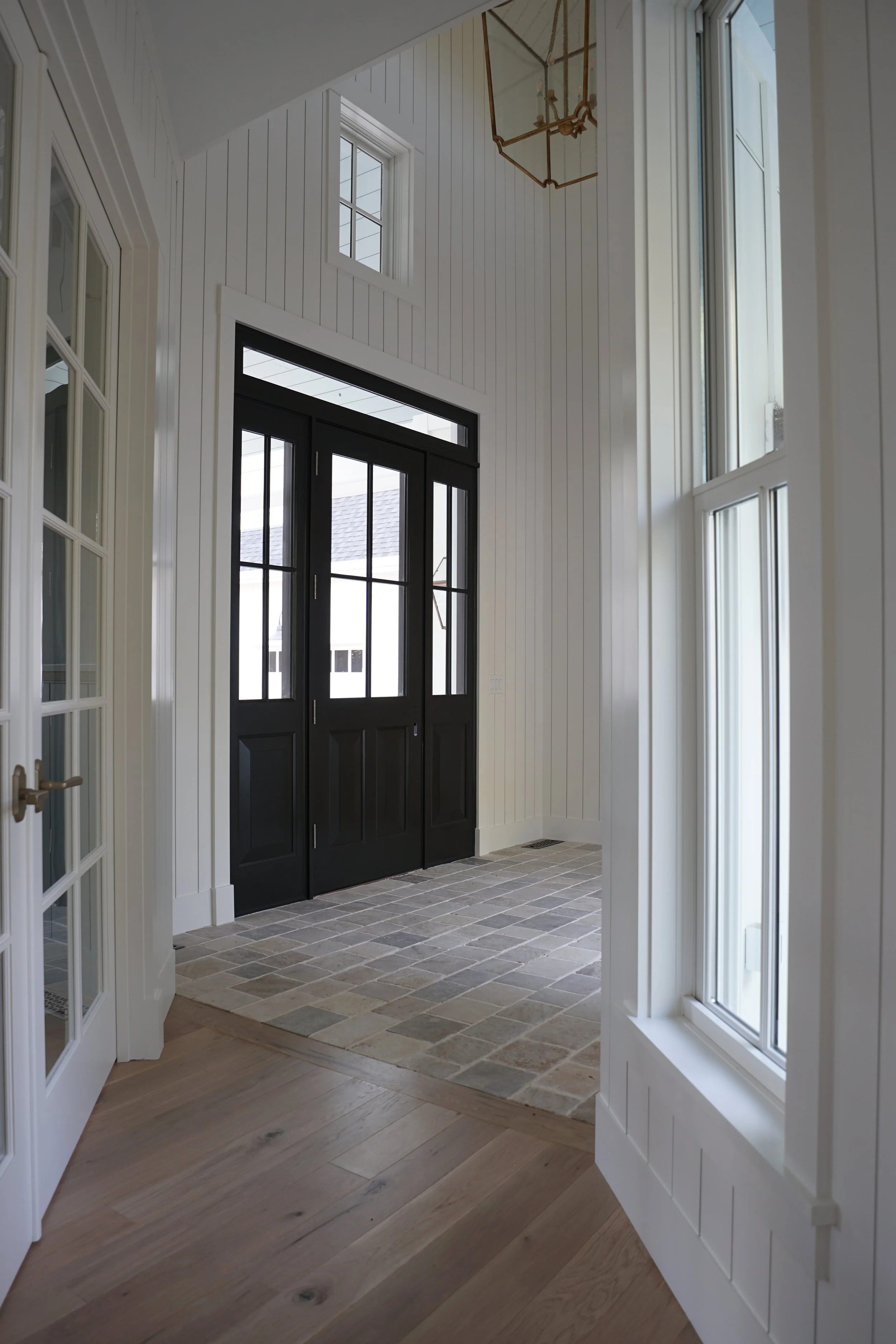 Luxury Rhode Island coastal home by Spinazzola Interiors featuring European farmhouse architecture, custom millwork and timeless coastal interiors.