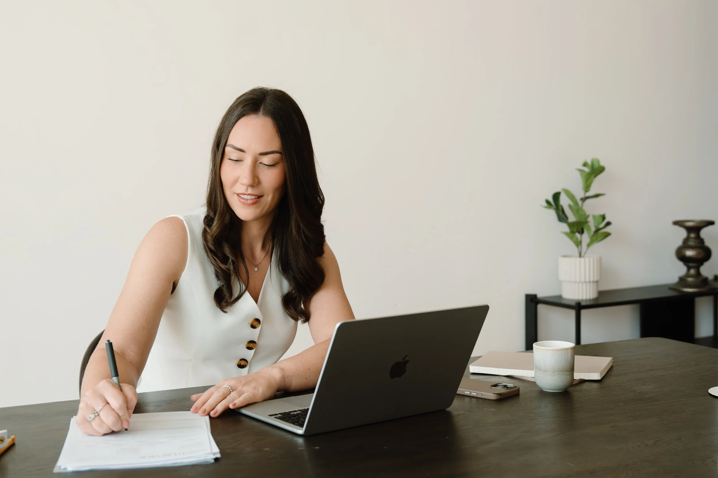 Rachel Bendle, Founder of The Early Years Advisory, working at a desk in Dubai.