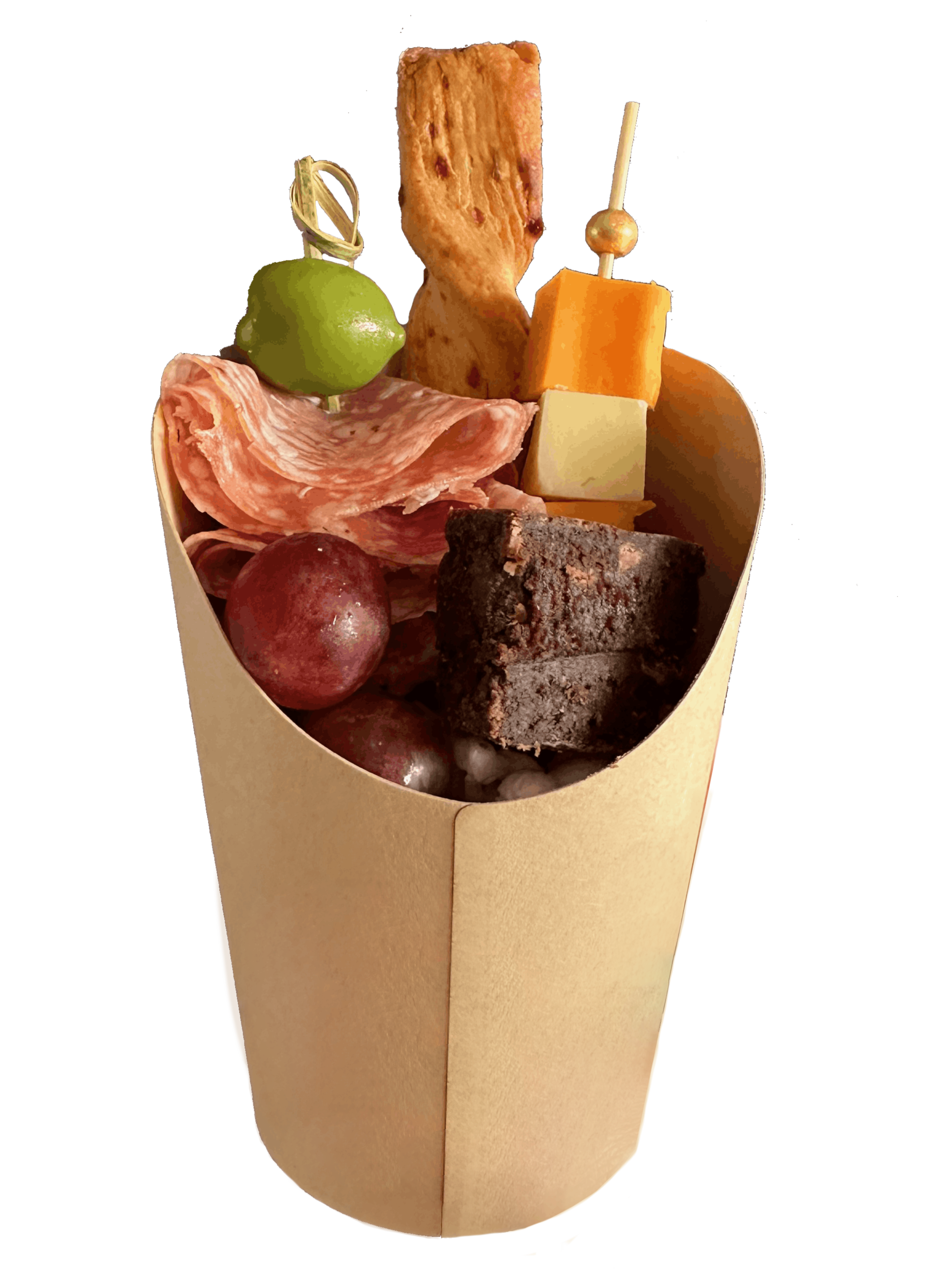 An assortment of foods including green olives, slices of salami, red grapes, cheese cubes, a cheese twist, and a chocolate brownie bite, all arranged in a paper cone.