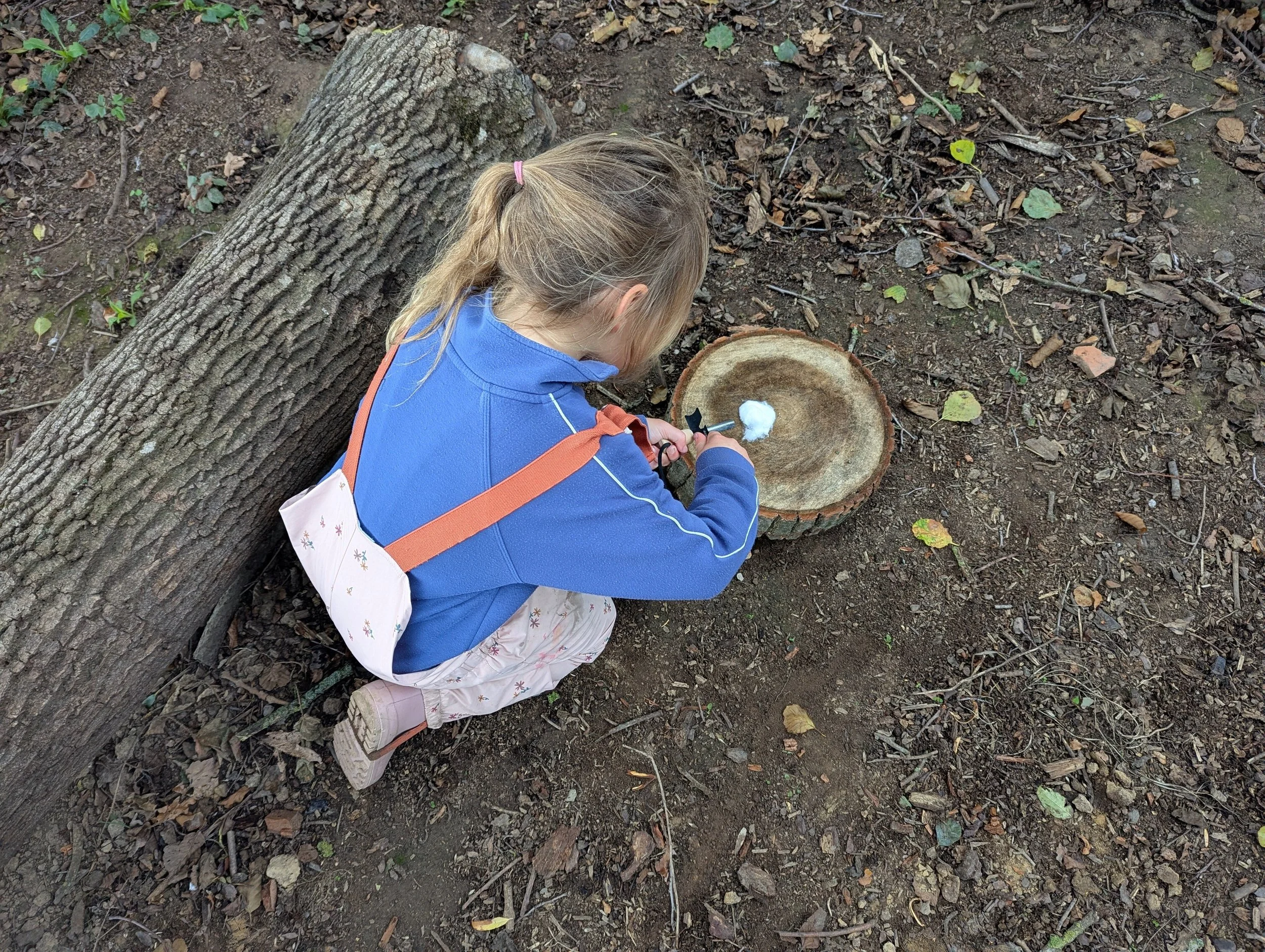 Practising firelighting skills using flint and steal