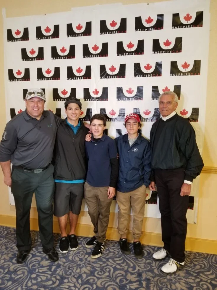 Five people standing in front of a backdrop with Canadian maple leaf logos and the text 'HALPEIPECA'. They are dressed in casual and semi-formal clothing, smiling at the camera.