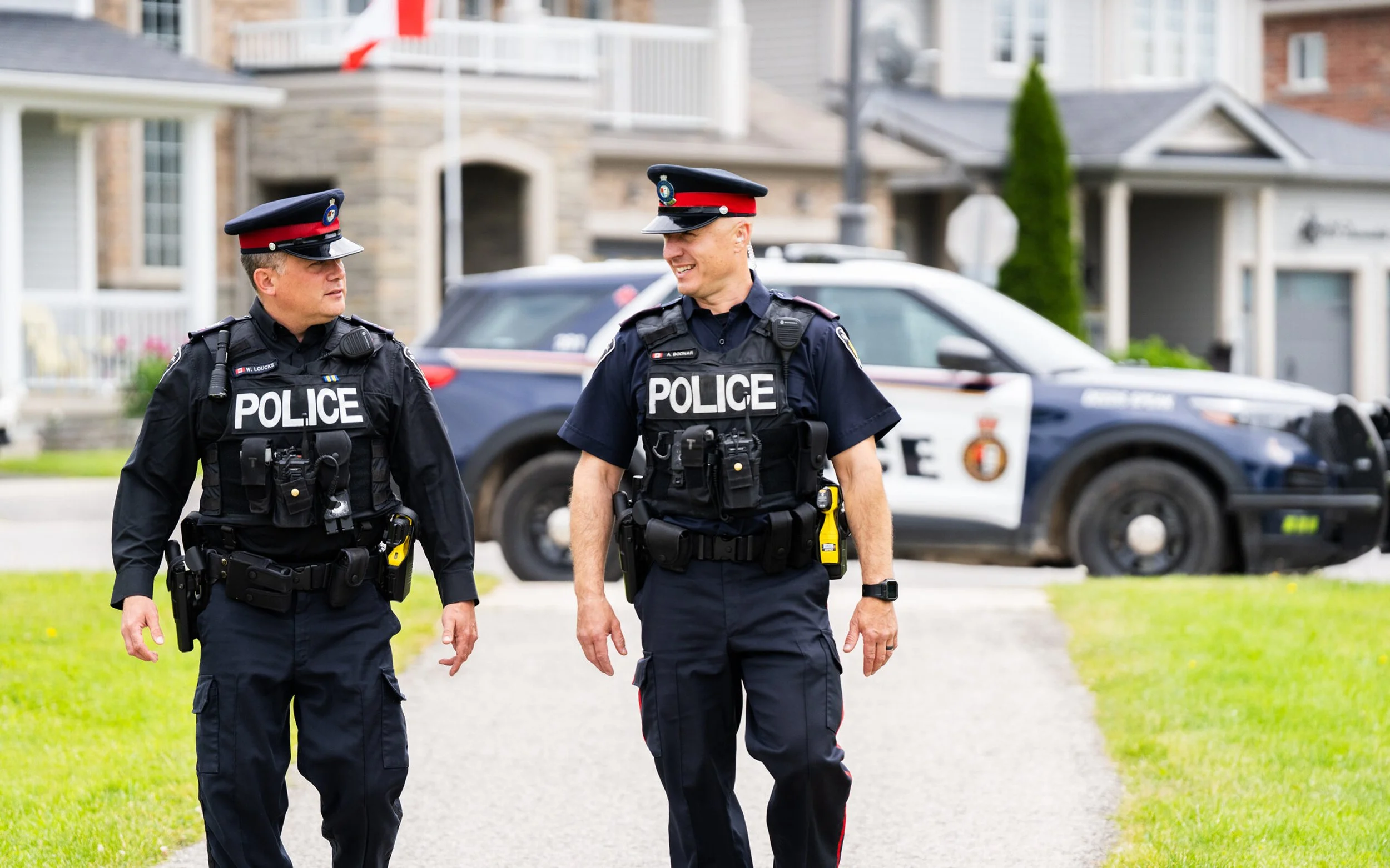 Nobleton Neighborhood Watch sign with three red houses and police badge logo