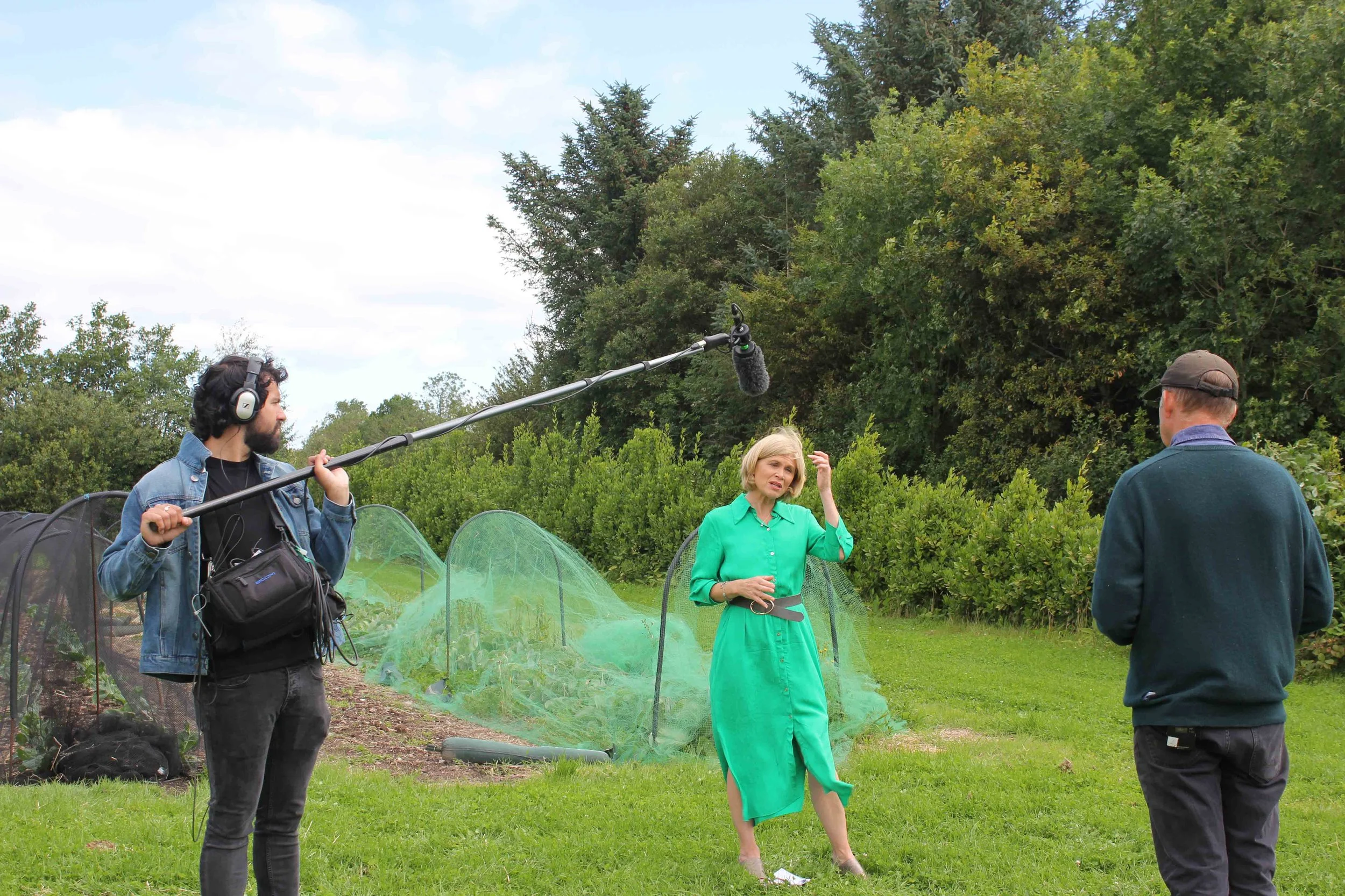 Jordan Murshed recording location sound with a boom microphone during a Nationwide shoot for RTÉ One featuring presenter Anne Cassin.