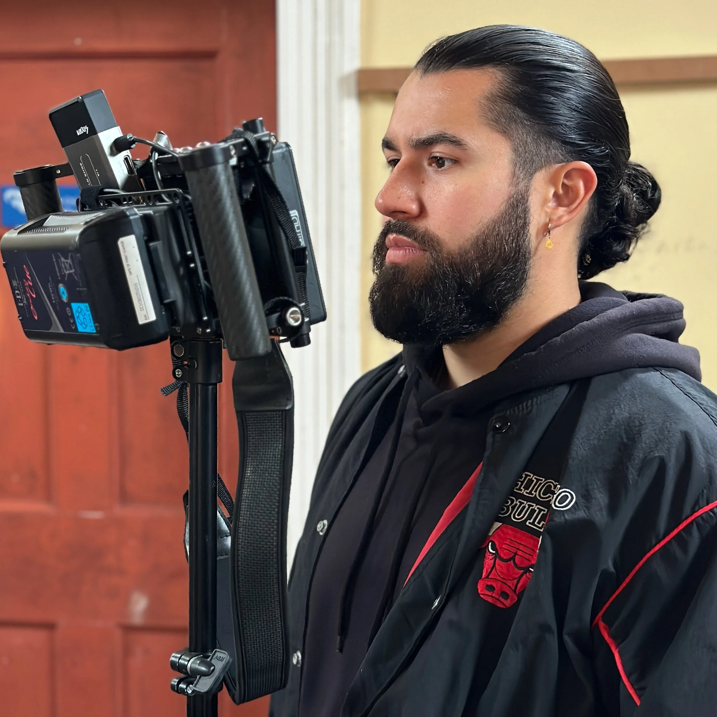Writer and director Jordan Murshed reviewing a live camera feed and overseeing production during a film shoot in Ireland.