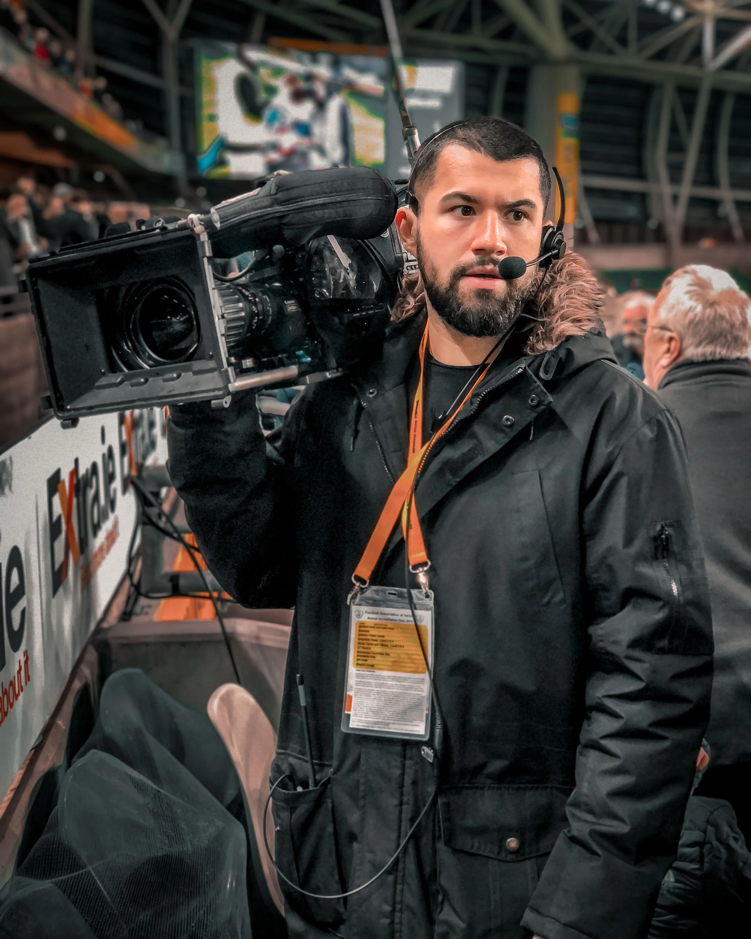 Jordan Murshed operating a broadcast camera during a live sporting event for Irish television.