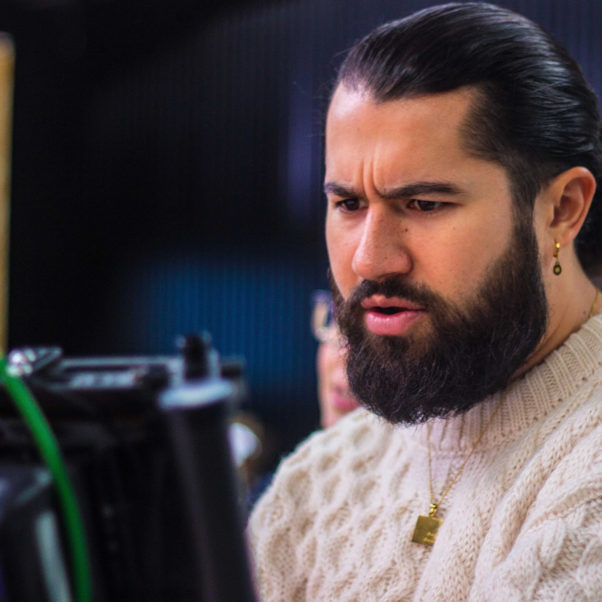 Jordan Murshed reviewing footage on a production monitor during a film shoot.