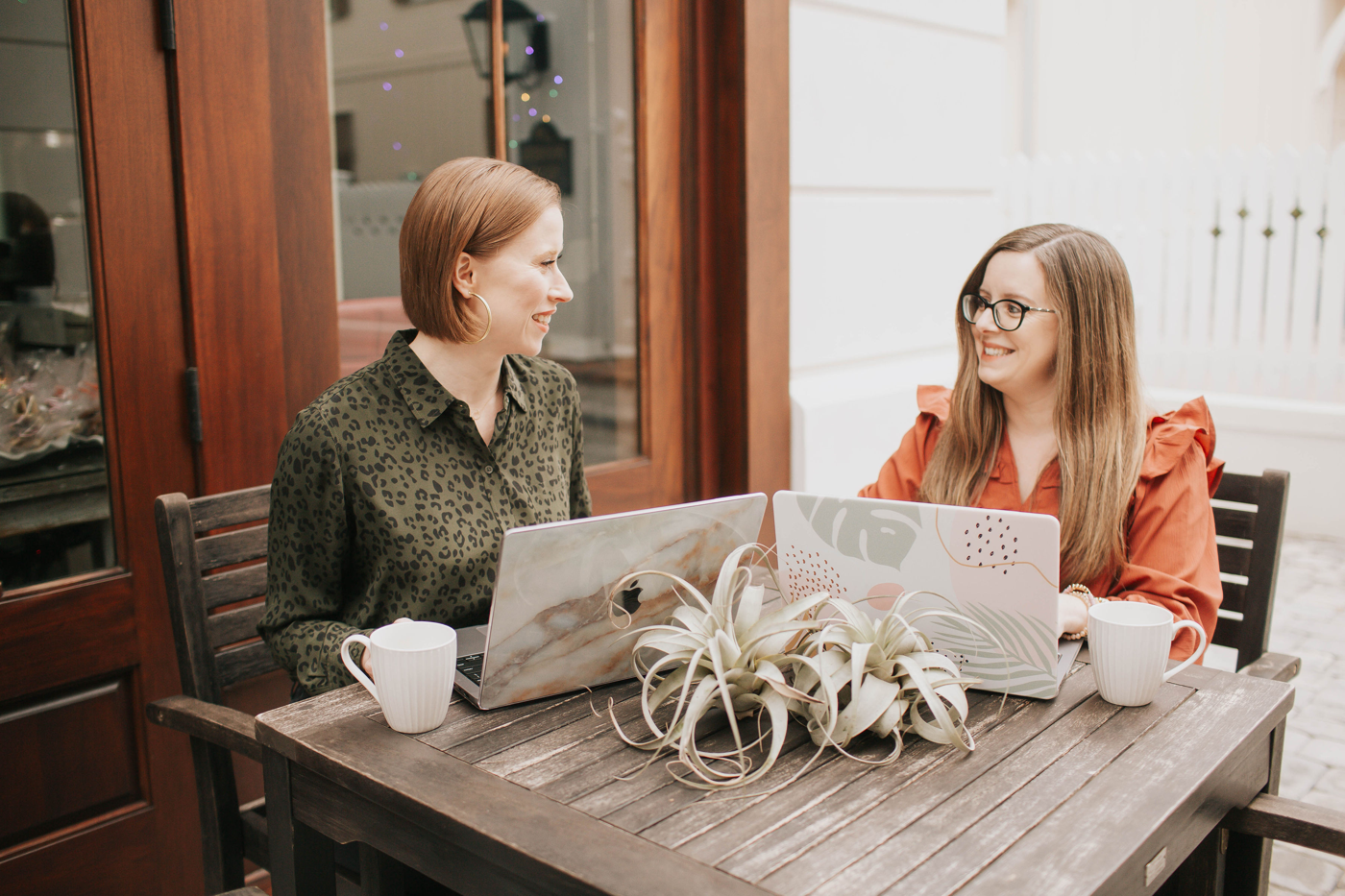 Natalie and a client smiling together over their laptops