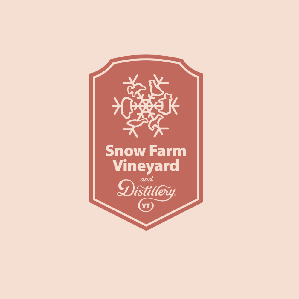 Logo for Snow Farm Vineyard and Distillery with a stylized snowflake design.
