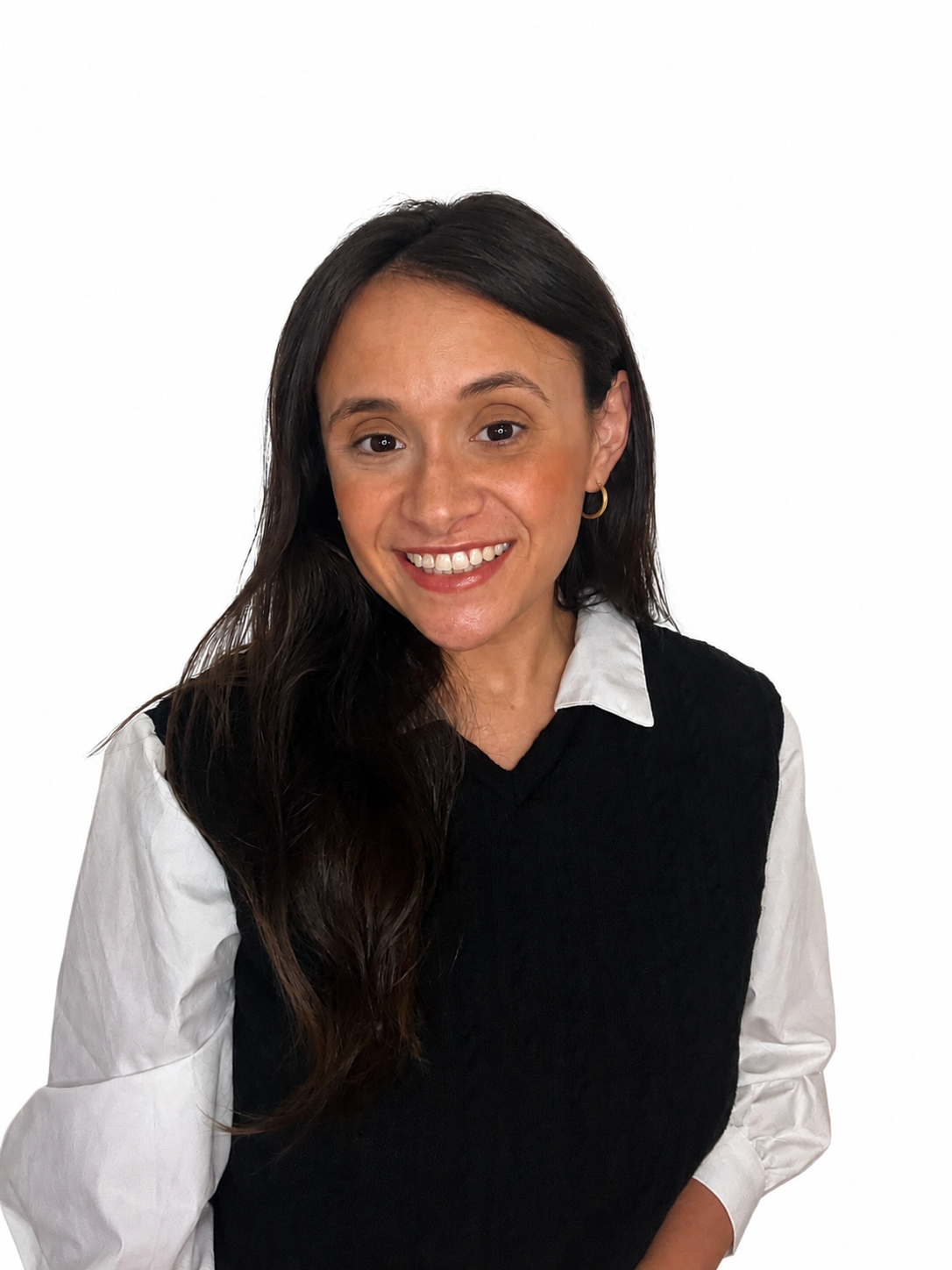 Portrait of a woman with long dark hair, smiling, wearing a black vest over a white shirt, with a white background.