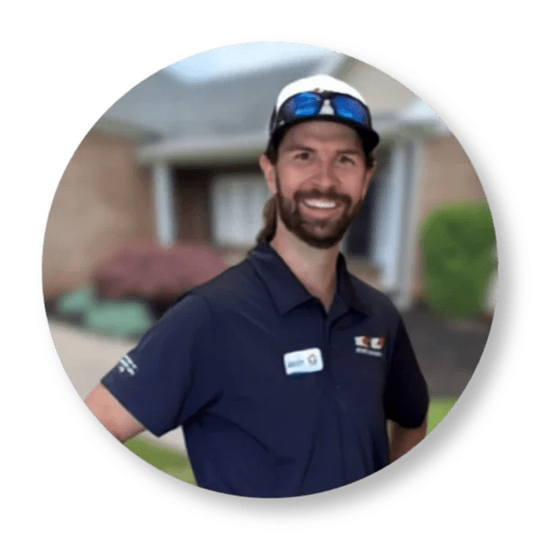 Brian Mehalso owner of Hot Shot Pressure Washing in Salem Virginia smiling in uniform in front of a residential property.