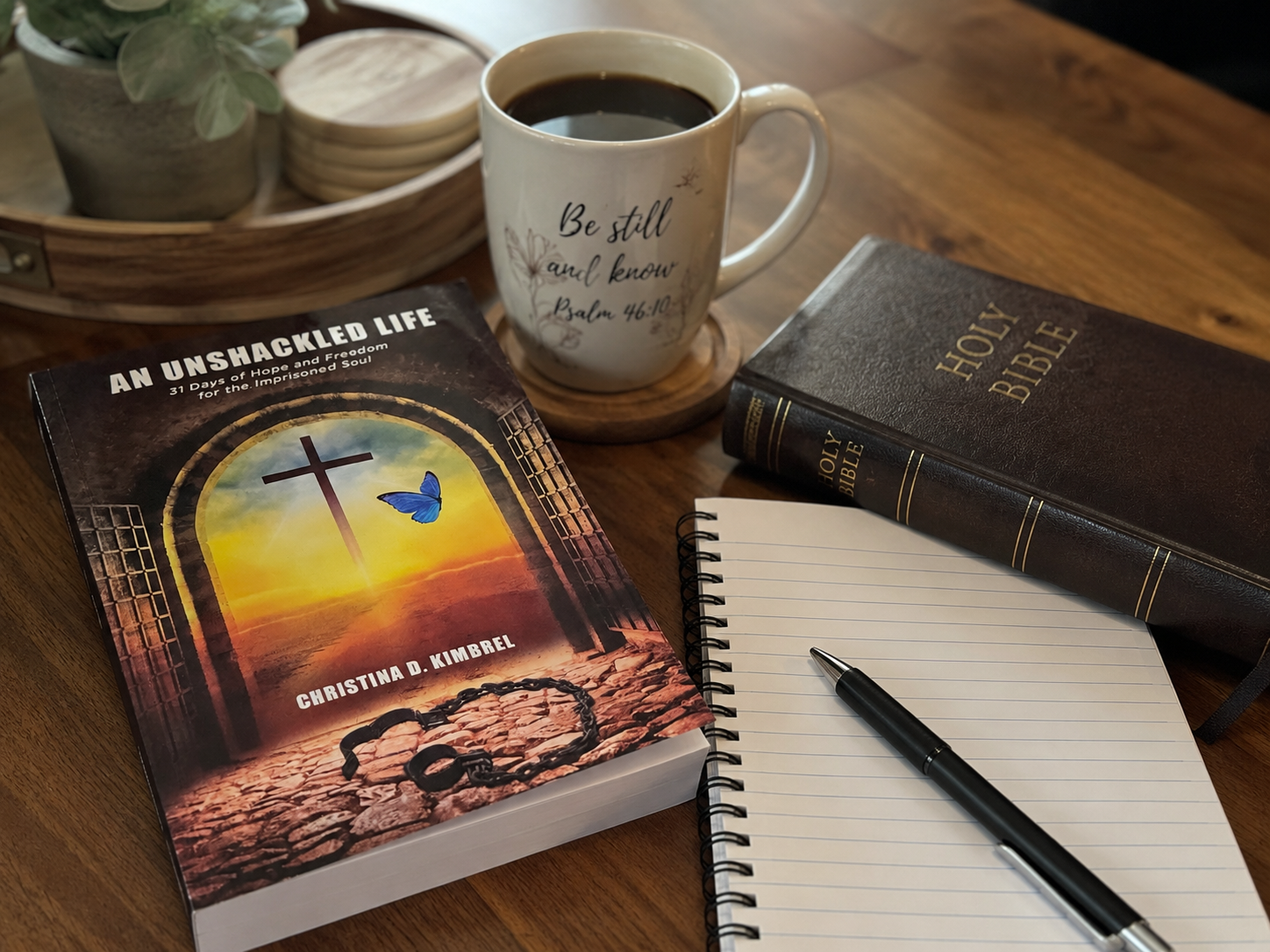 Christina Kimbrel’s book An Unshackled Life beside a Bible, coffee, and journal