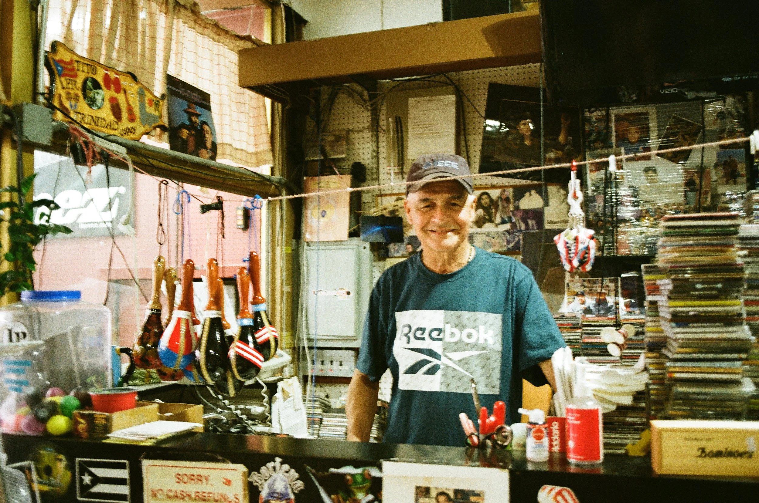 Carlos from Johnny Albino Music Store recounting his personal journey from Orocovis, Puerto Rico to New York City