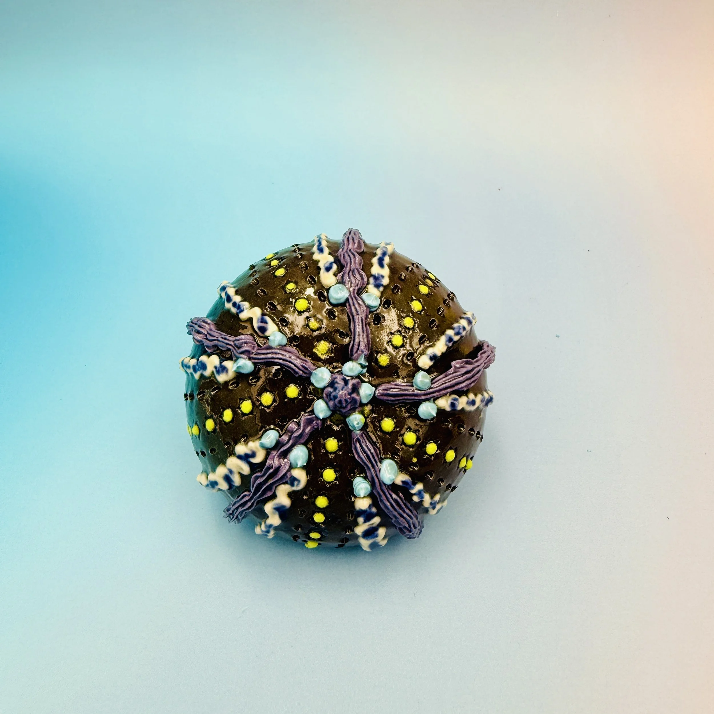 An intricately decorated ceramic sea urchin