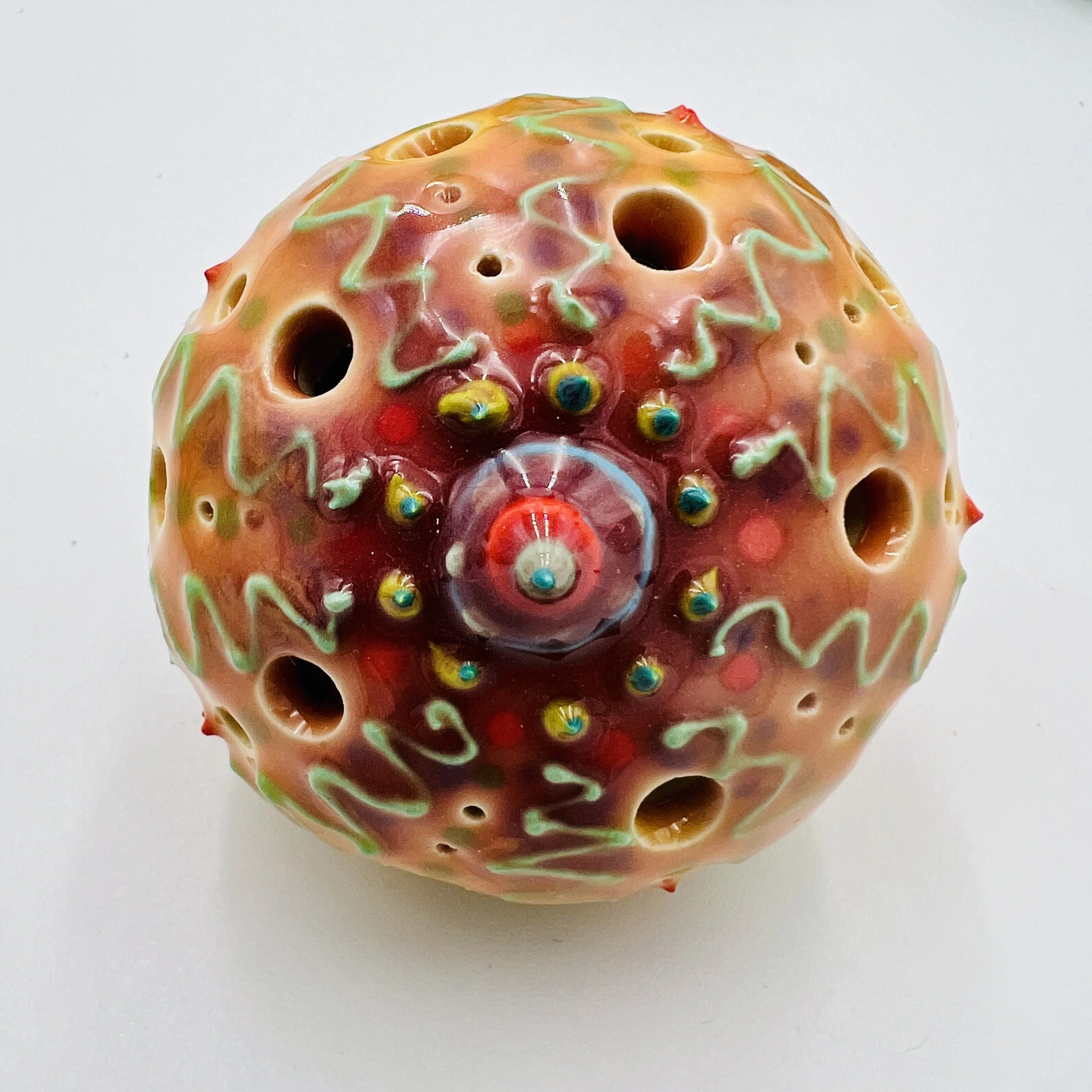 An intricately decorated ceramic sea urchin