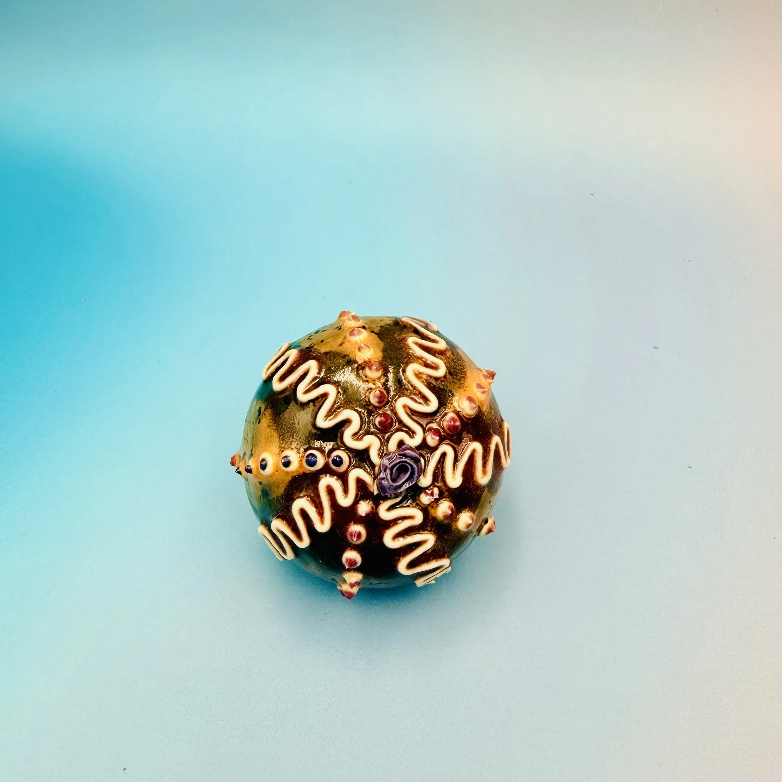 An intricately decorated ceramic sea urchin