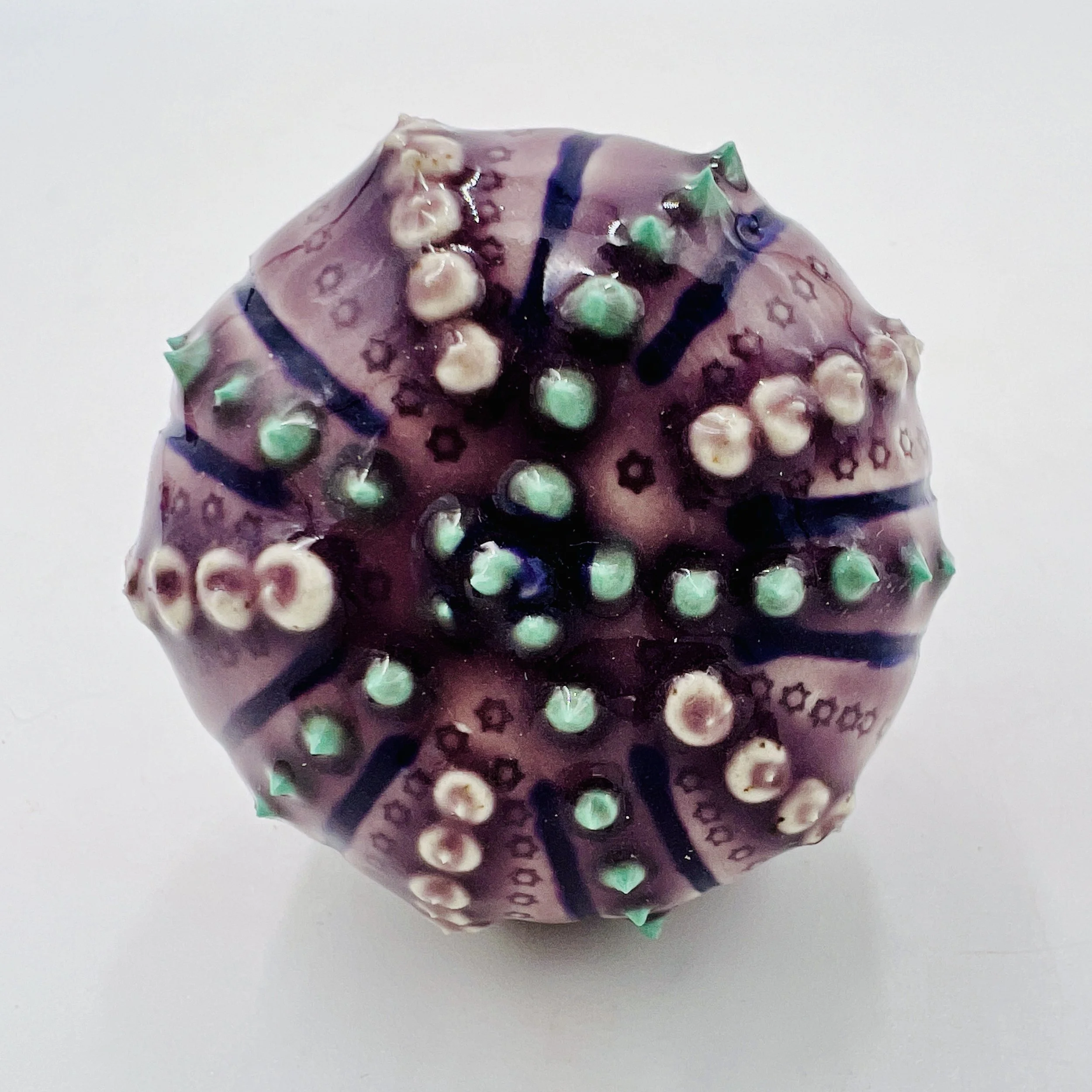 An intricately decorated ceramic sea urchin