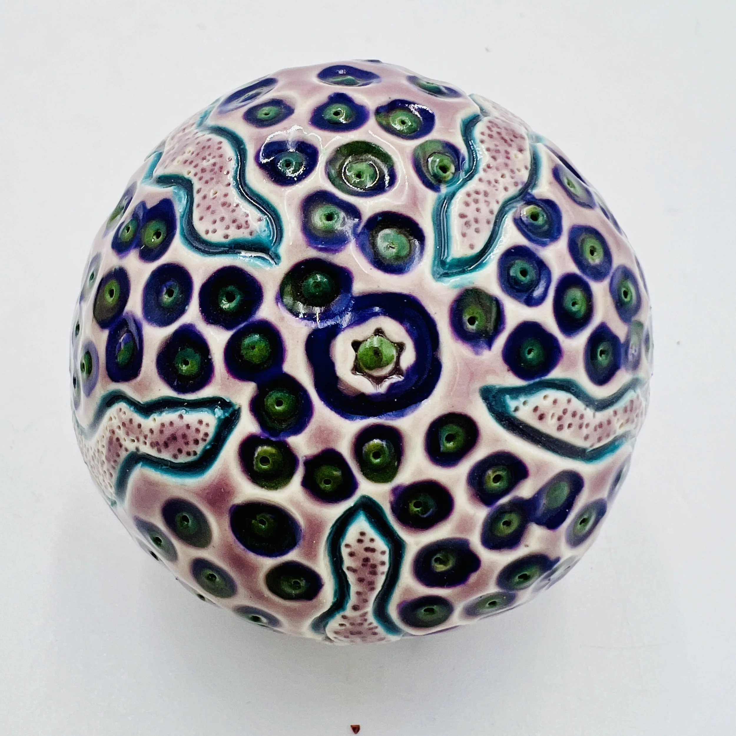 An intricately decorated ceramic sea urchin
