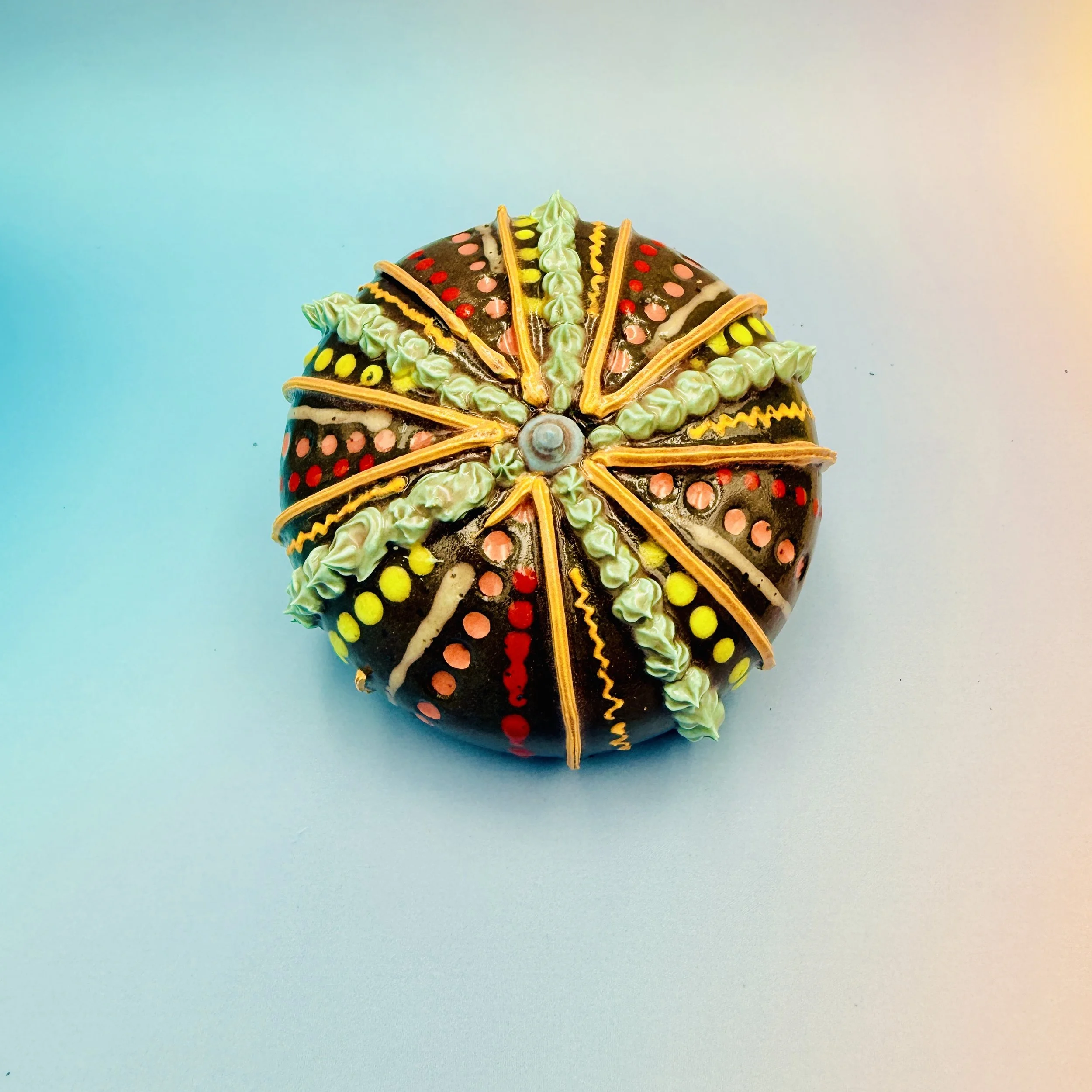 An intricately decorated ceramic sea urchin