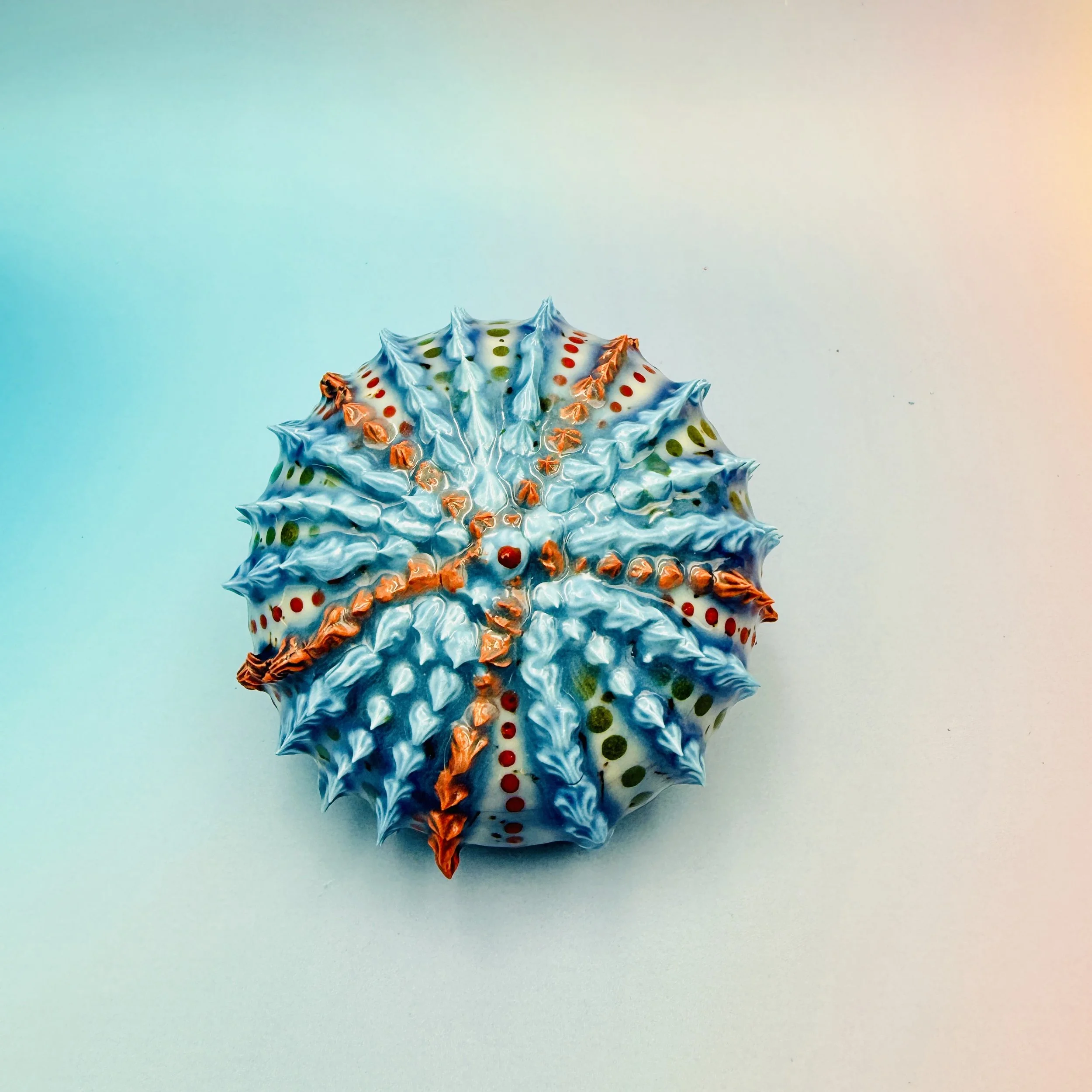 An intricately decorated ceramic sea urchin