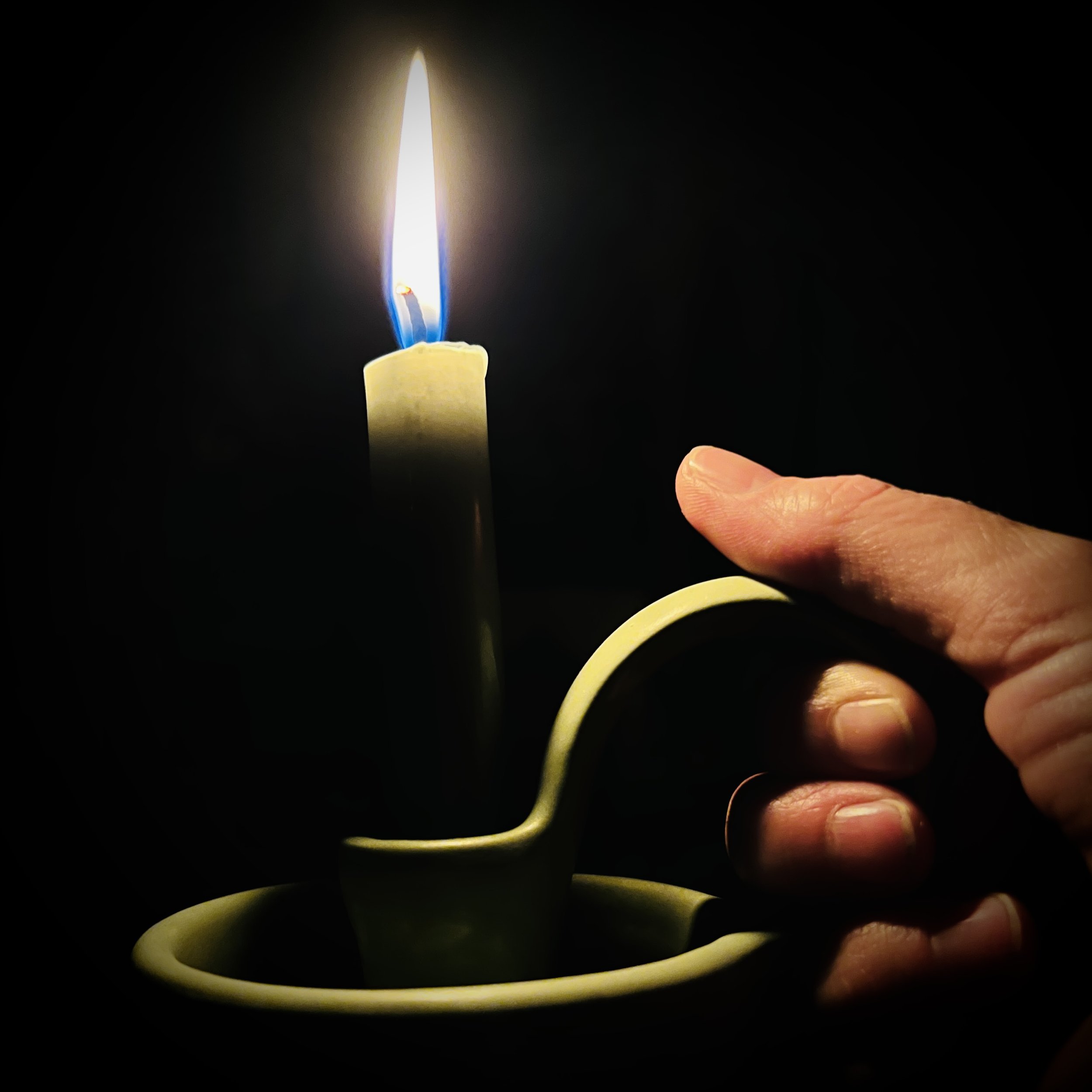  ceramic candle stick holder with a burning candle