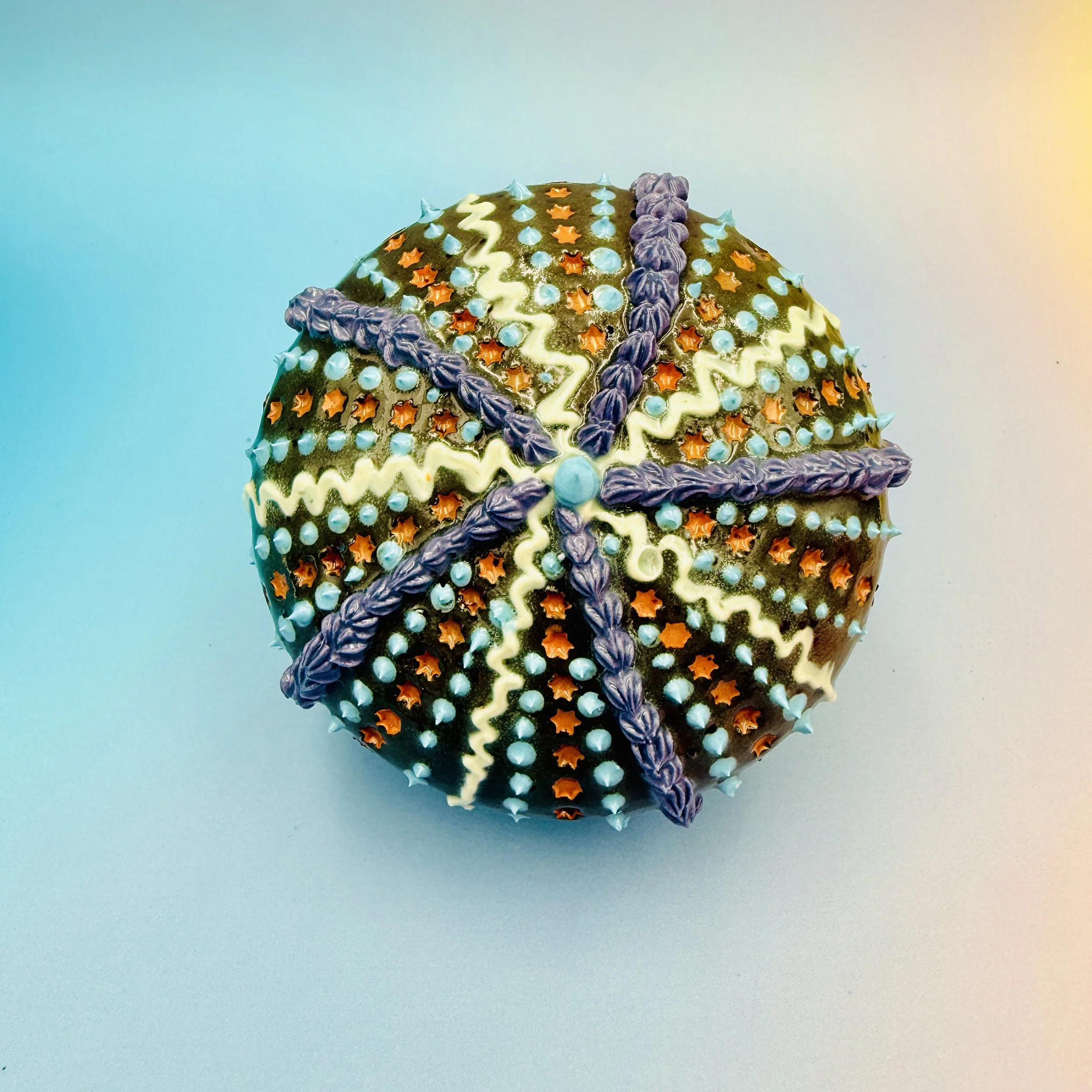An intricately decorated ceramic sea urchin