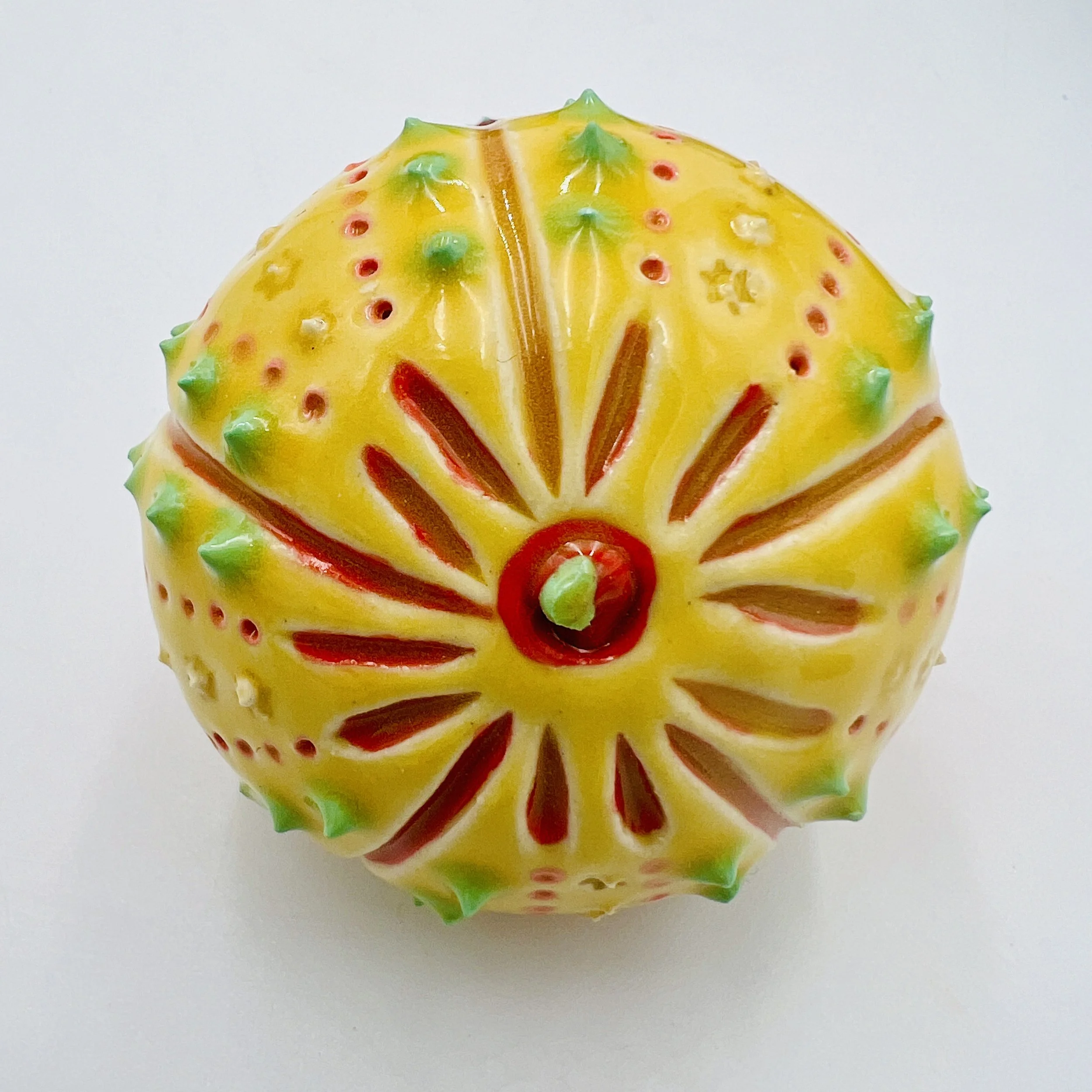An intricately decorated ceramic sea urchin