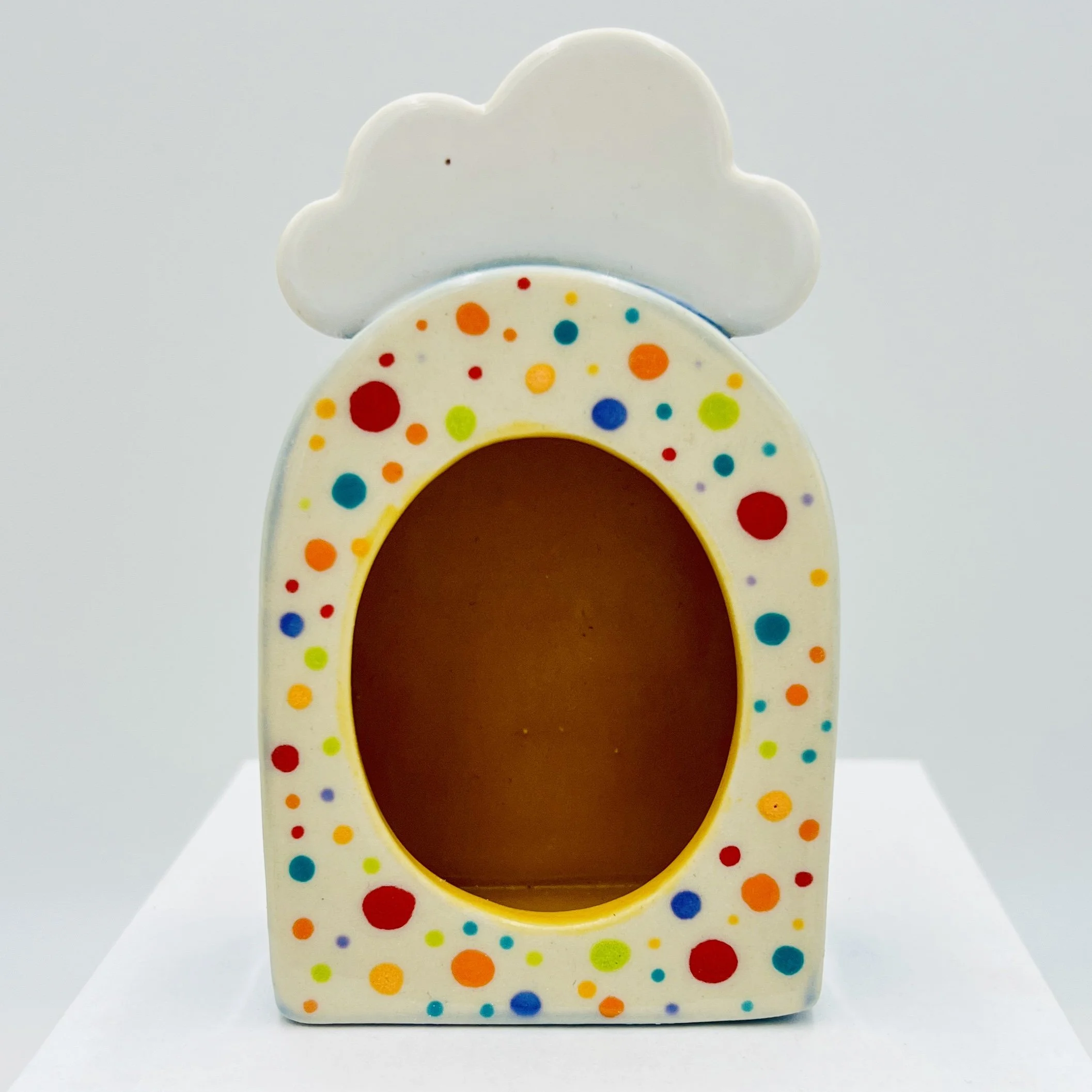  rainbow, polkadotted shrine with yellow insides with a white cloud on top