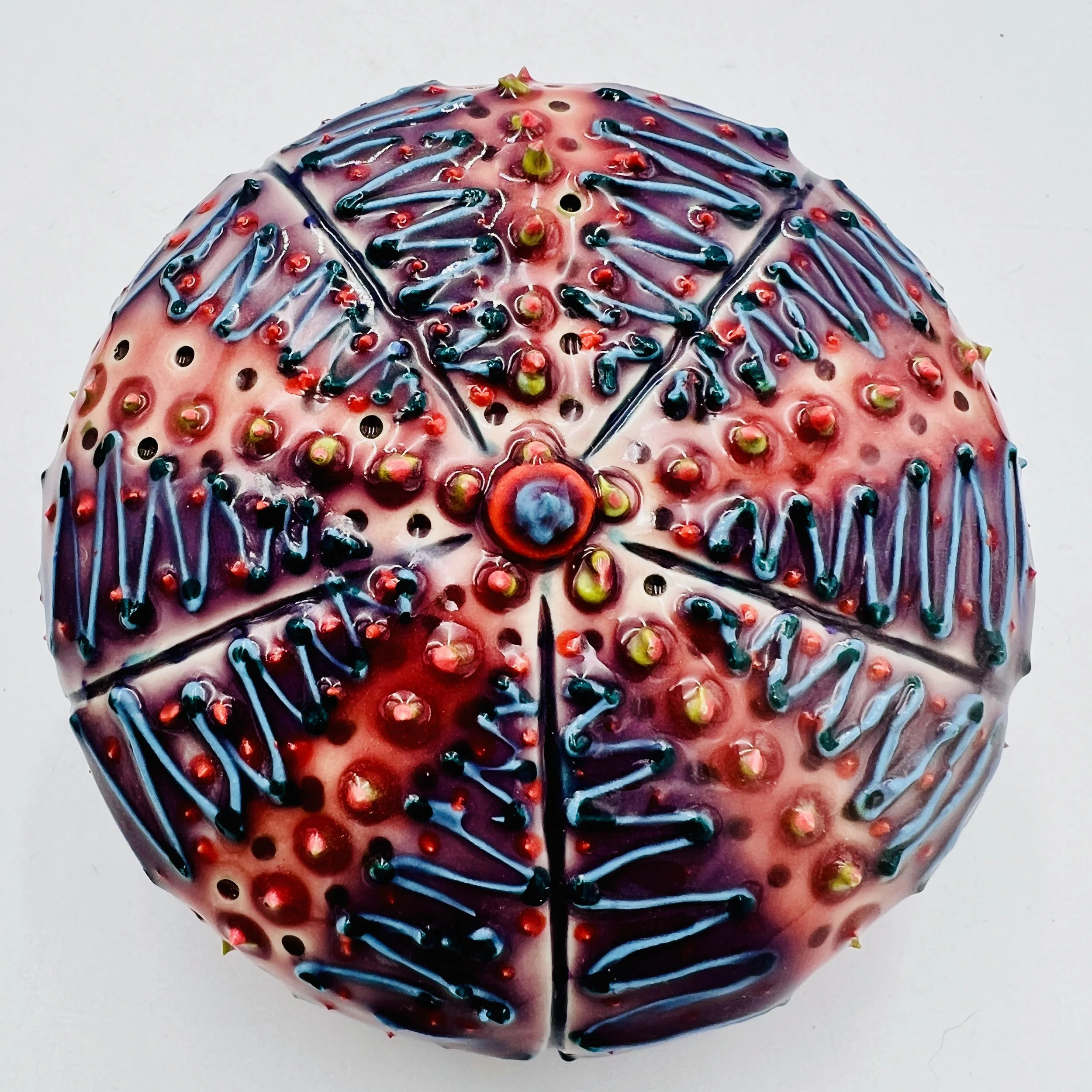 An intricately decorated ceramic sea urchin