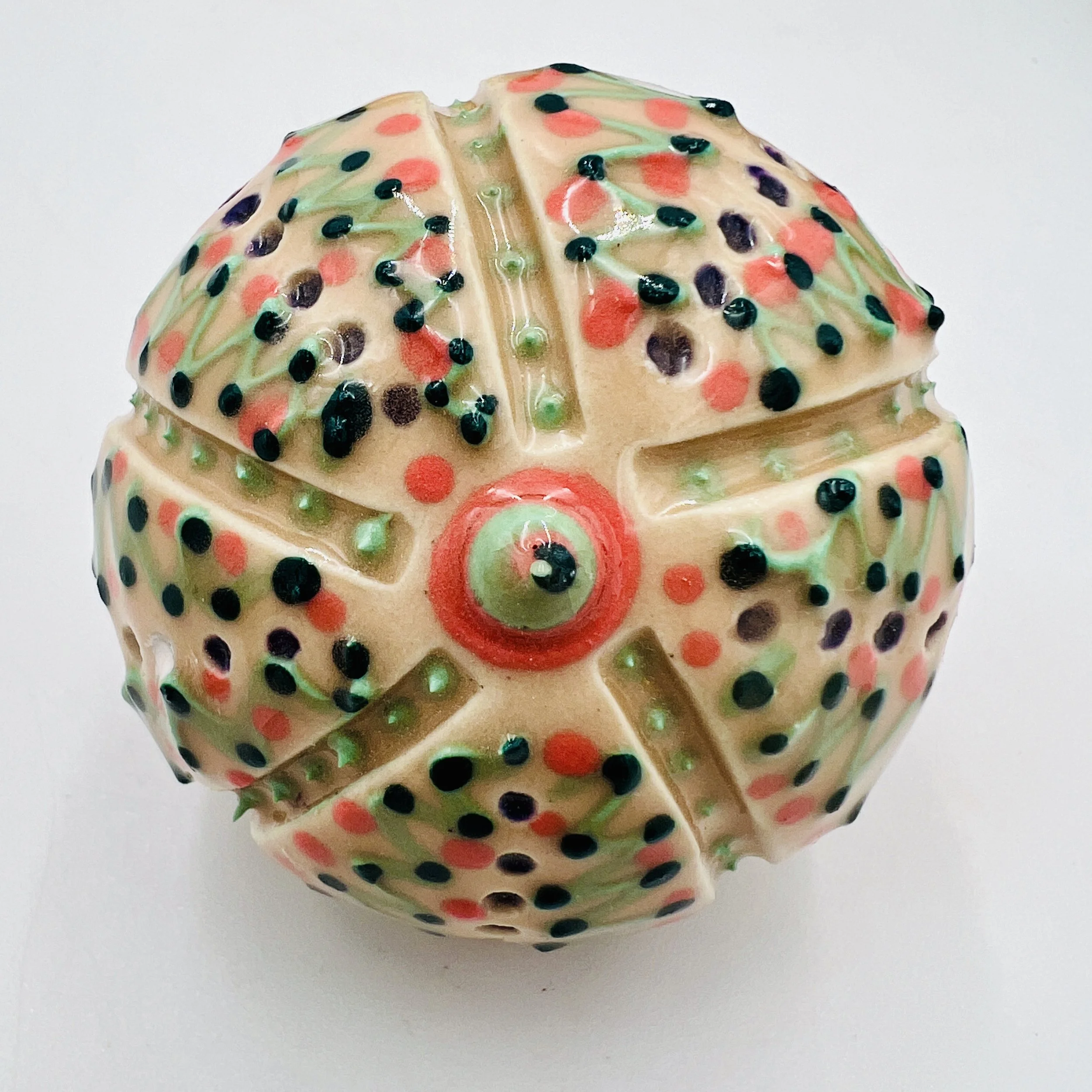 An intricately decorated ceramic sea urchin