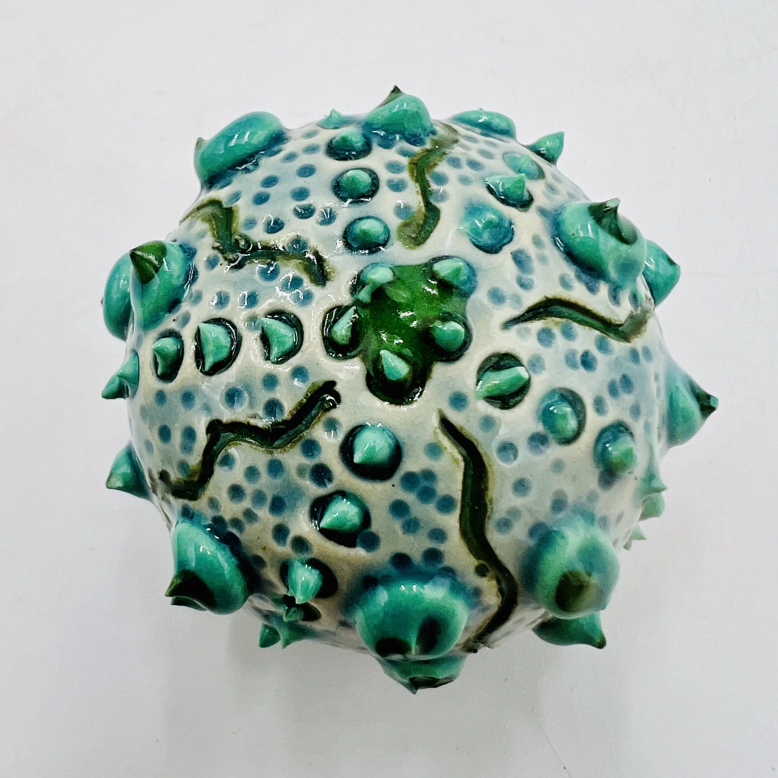 An intricately decorated ceramic sea urchin