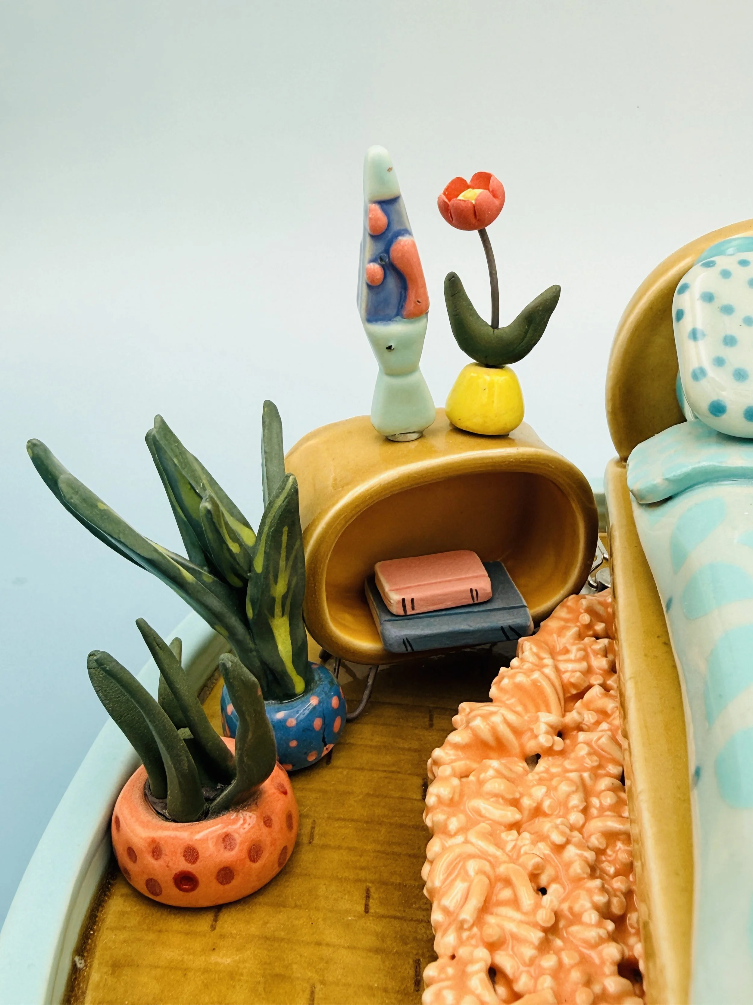  ceramic miniature, mid-century, modern inspired bedroom with bed, globe, lamps, shag, rug, potted plants, lava lamp, two kitties curled up under the bed