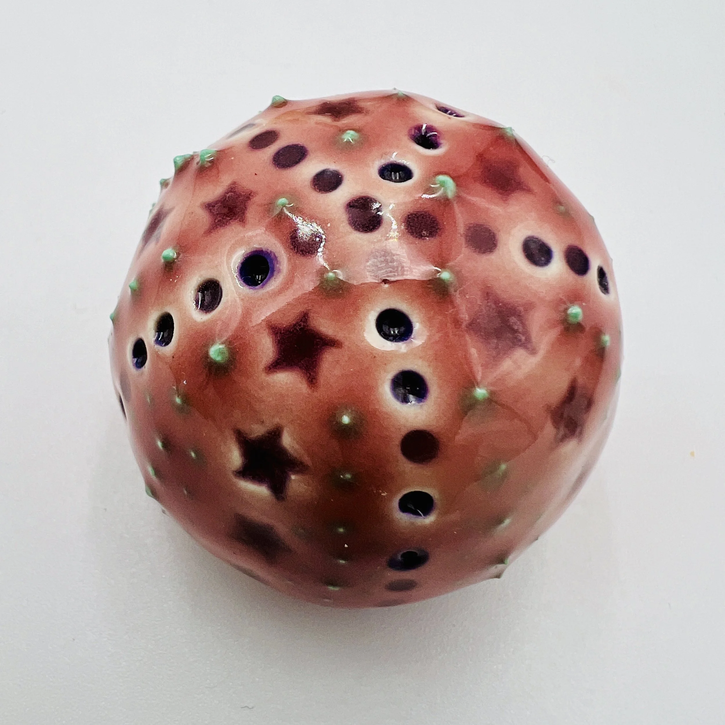 An intricately decorated ceramic sea urchin