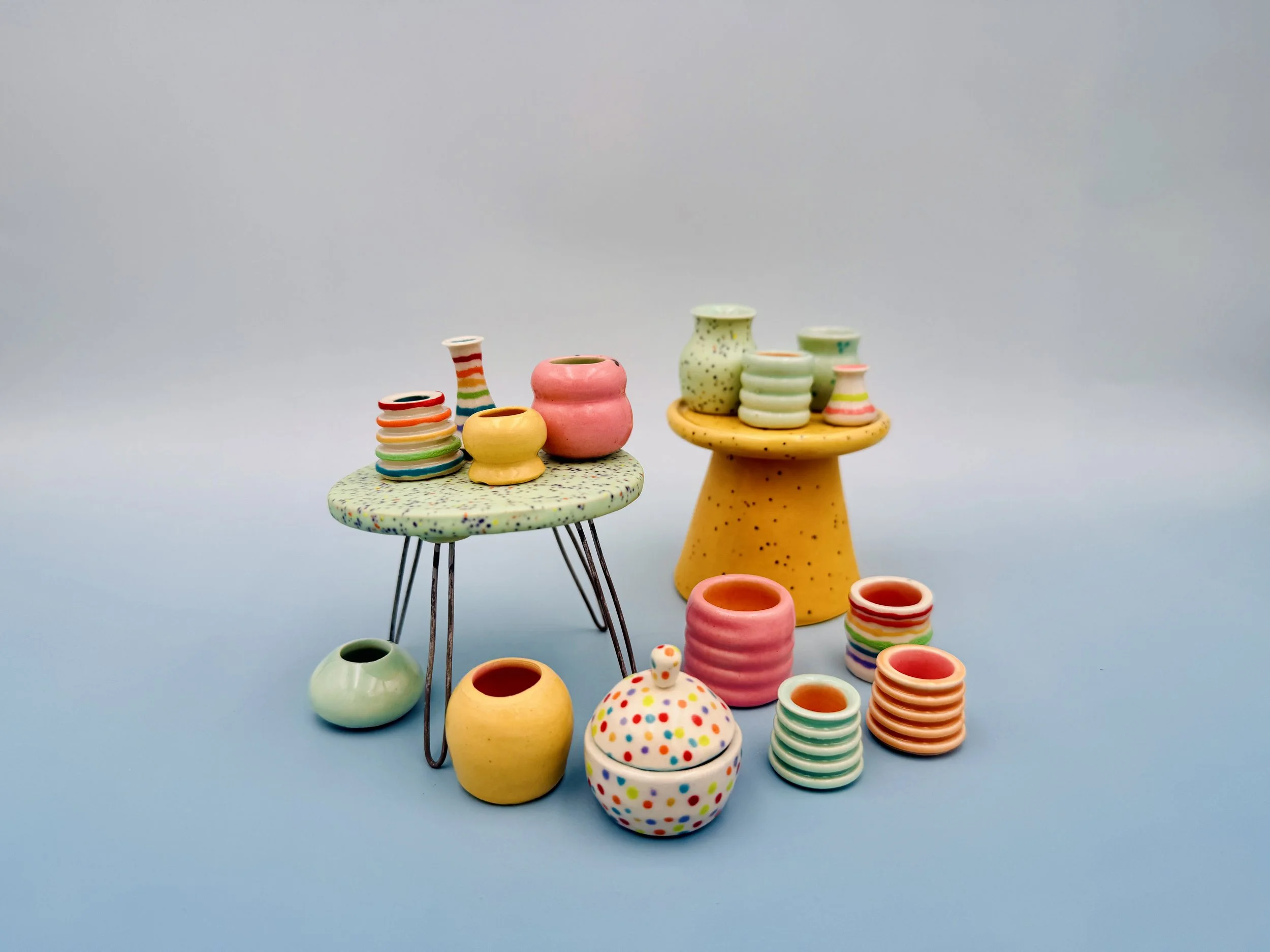Miniature Colorful Ceramic Pots on ceramic tables