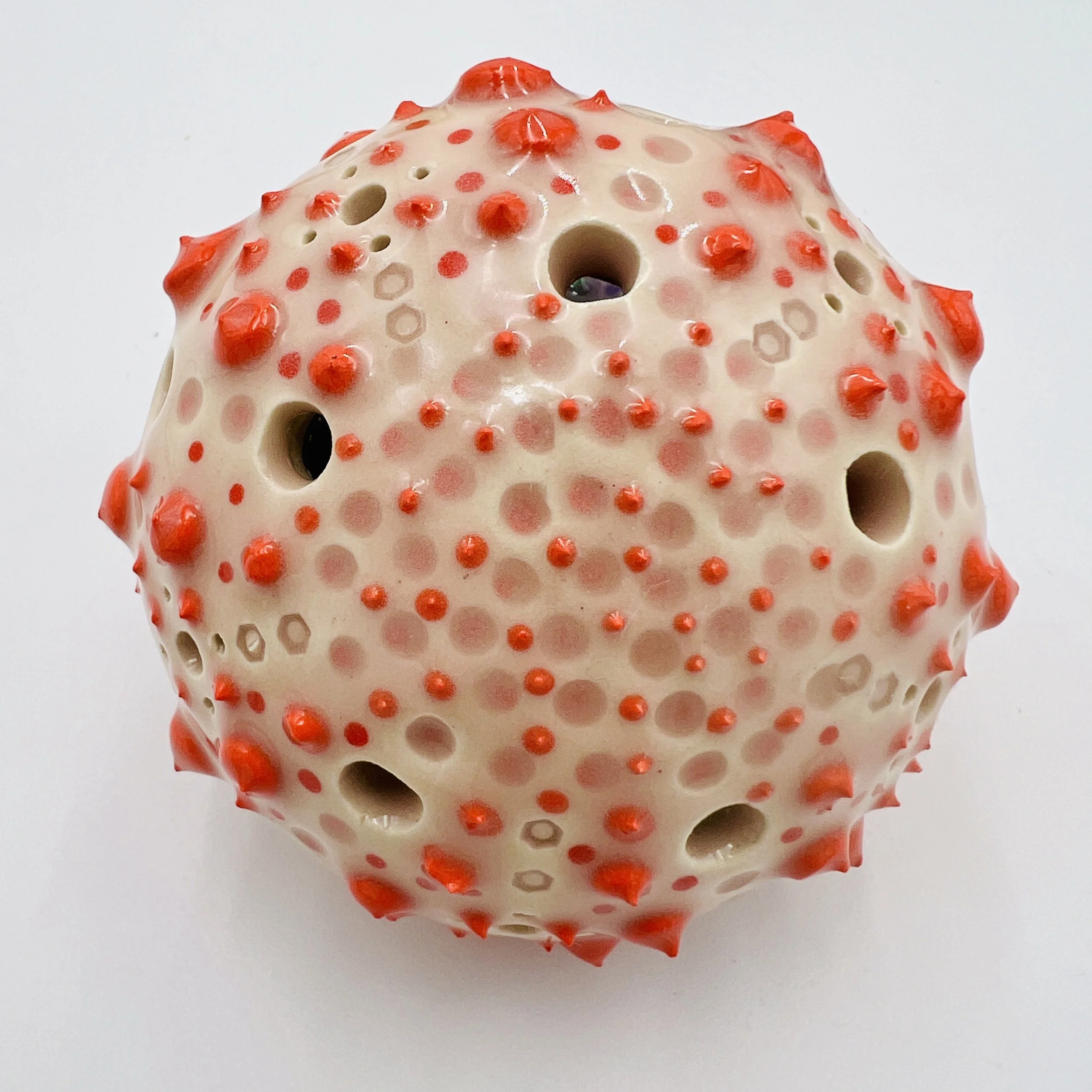 An intricately decorated ceramic sea urchin