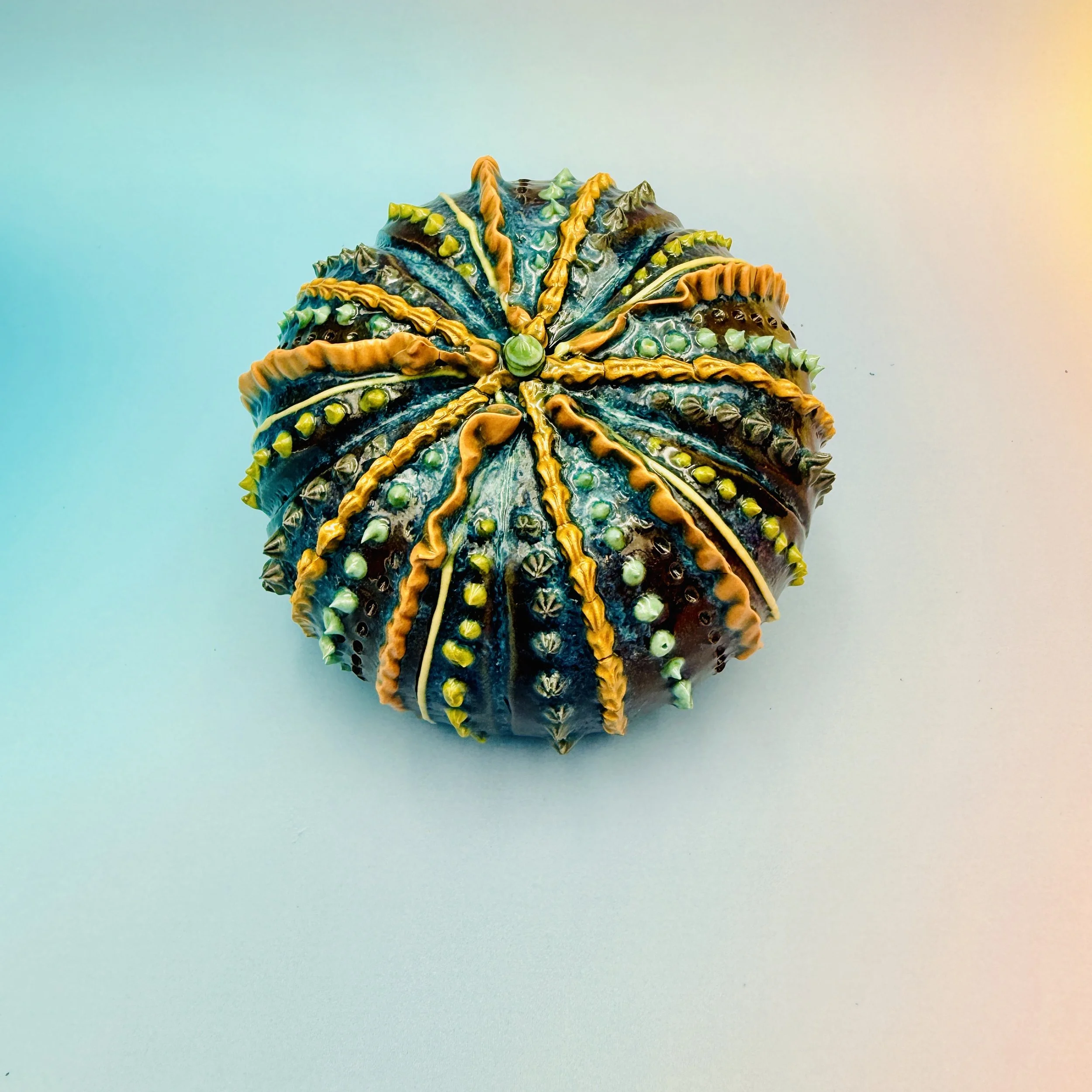 An intricately decorated ceramic sea urchin