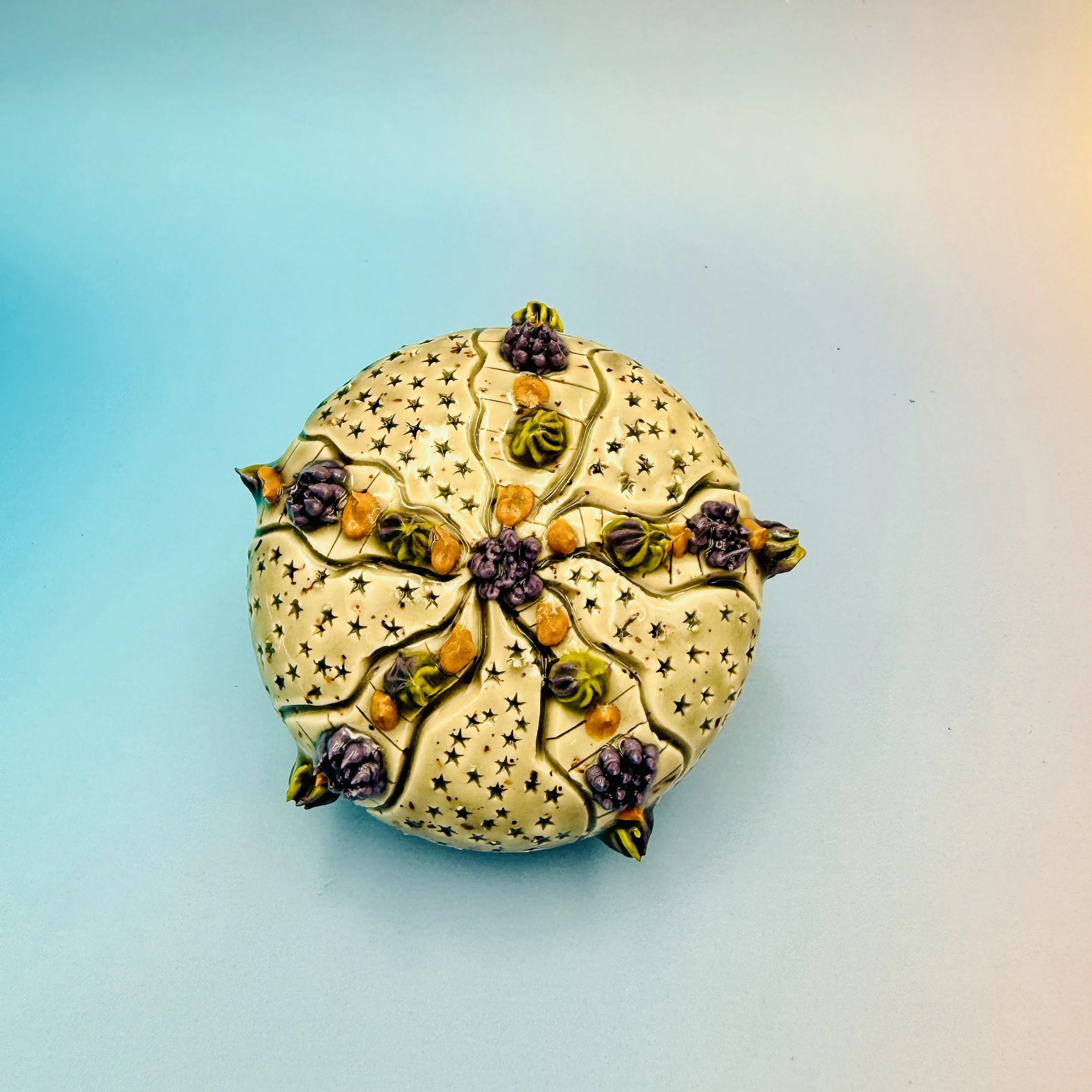 An intricately decorated ceramic sea urchin