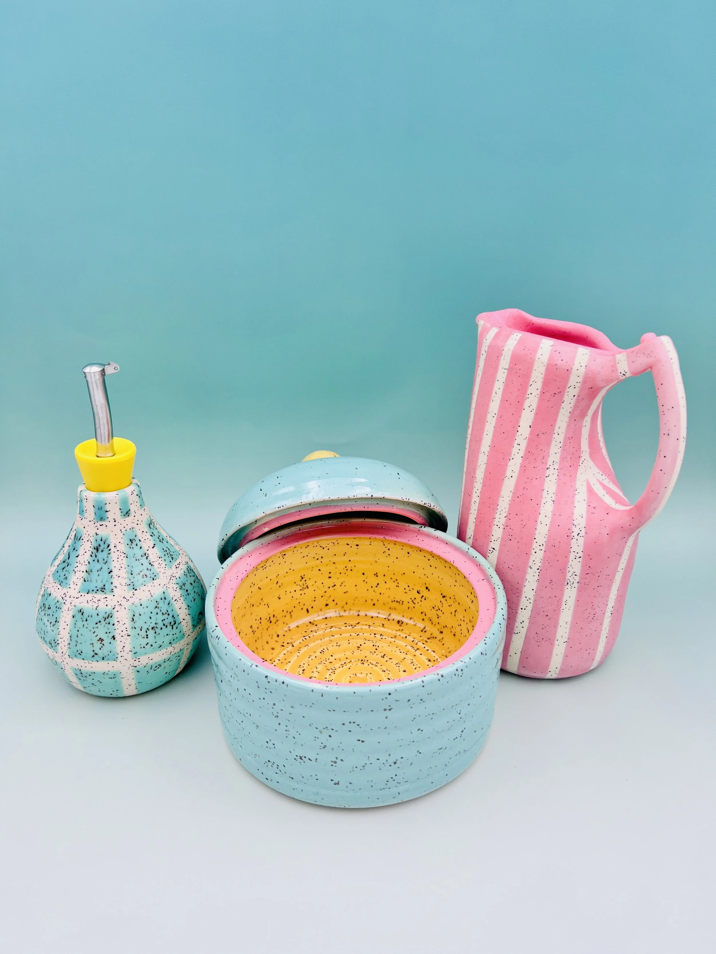  ceramic kitchen gadgets, an oil cruet, a litter jar, a pitcher