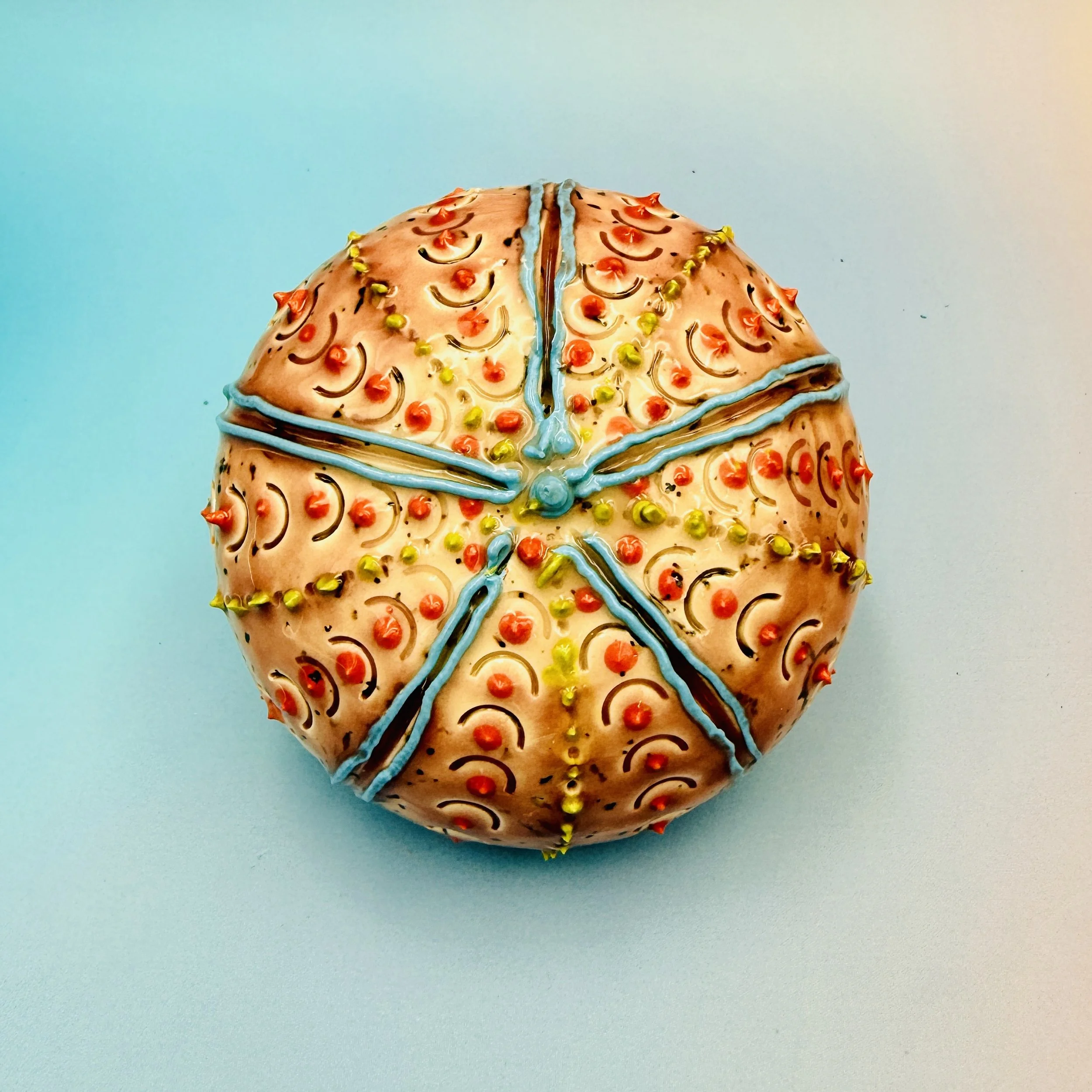 An intricately decorated ceramic sea urchin