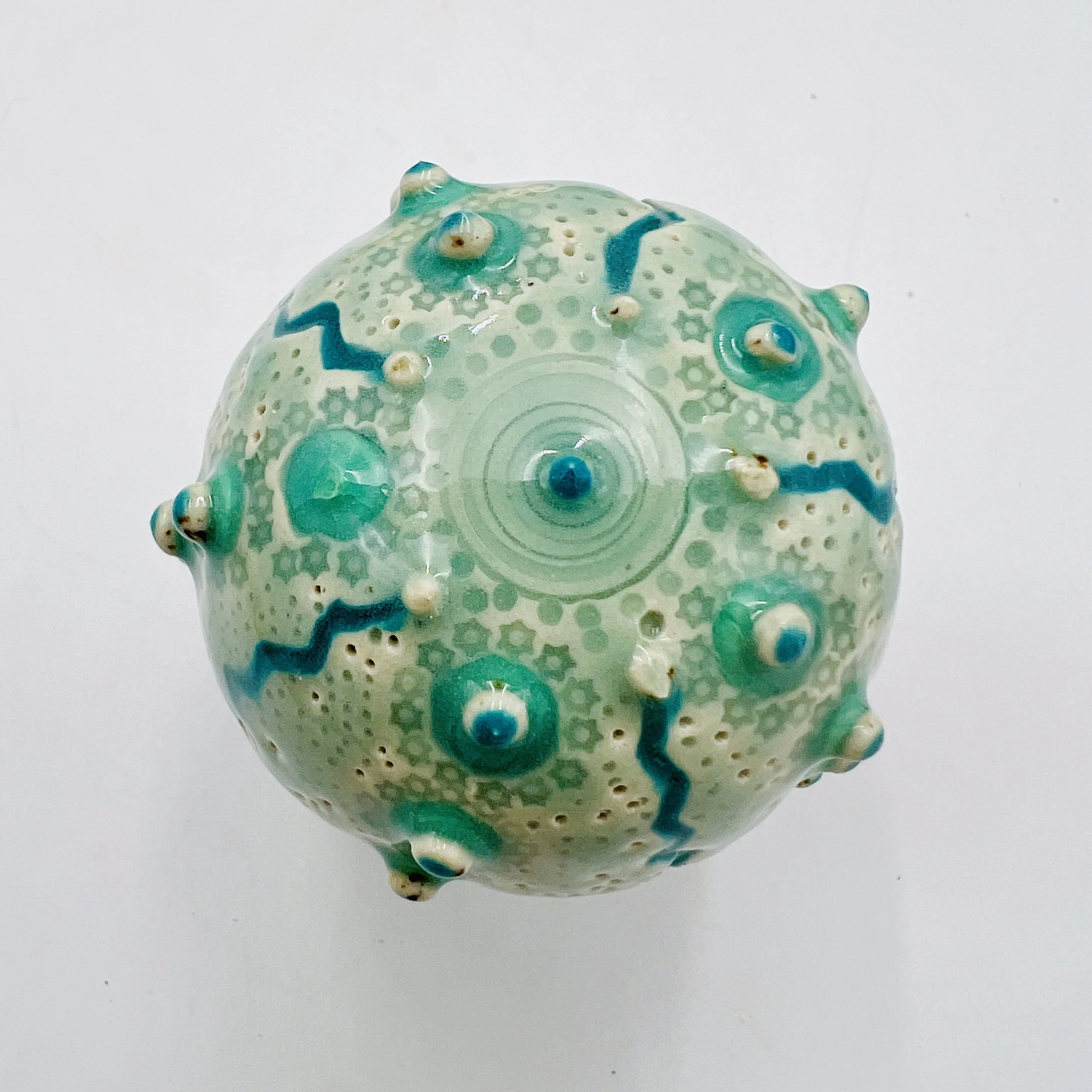 An intricately decorated ceramic sea urchin