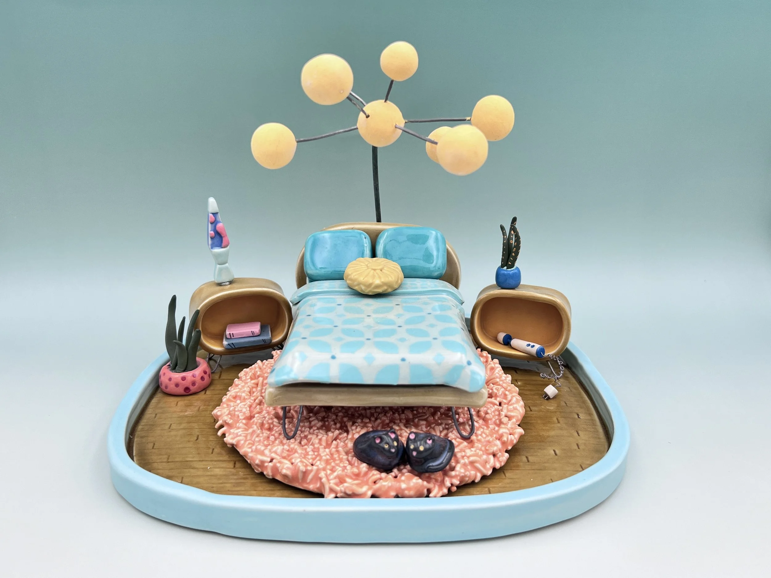  ceramic miniature, mid-century, modern inspired bedroom with bed, globe, lamps, shag, rug, potted plants, lava lamp, two kitties curled up under the bed