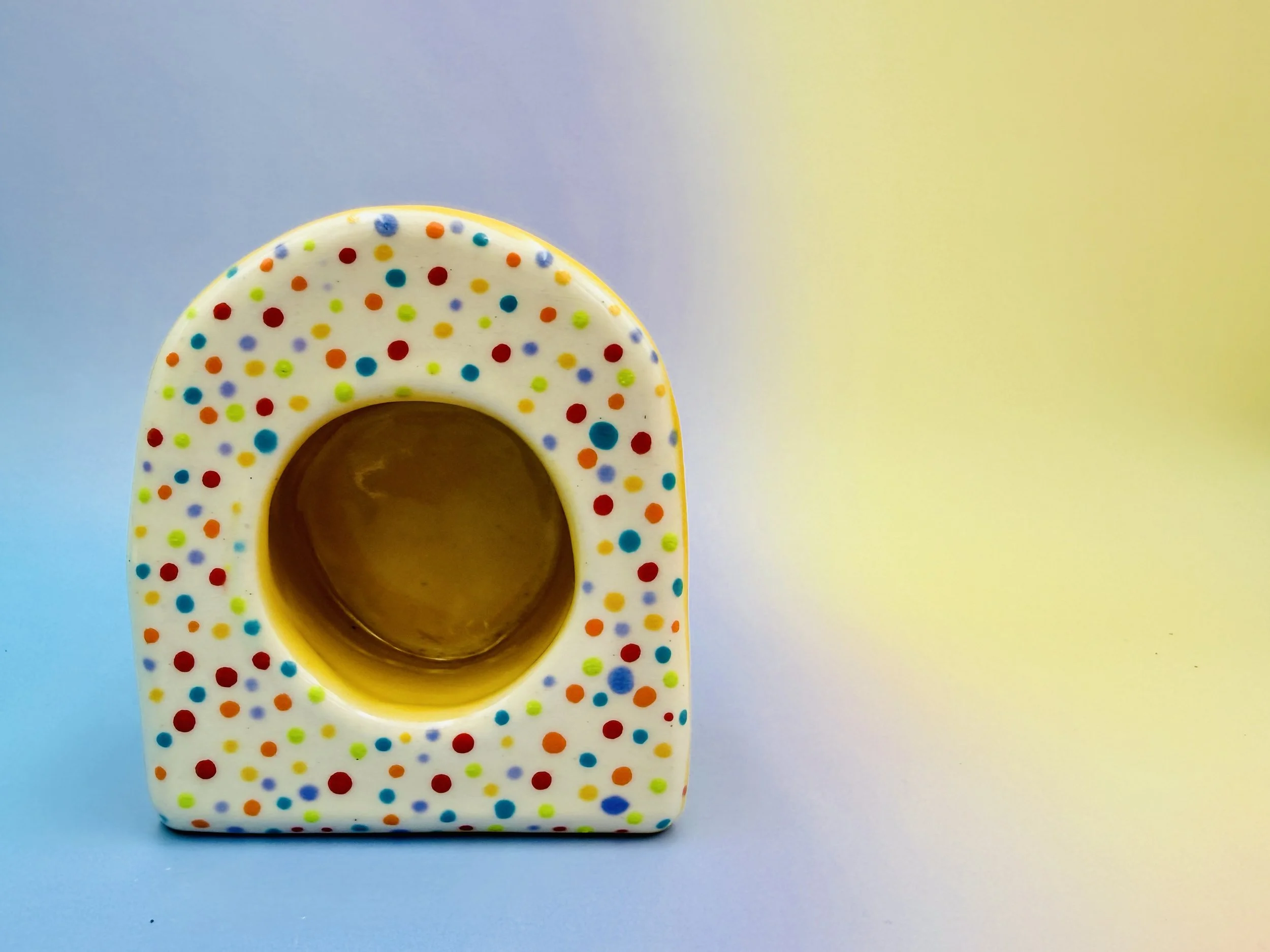  rainbow polkadotted shrine with yellow shelf