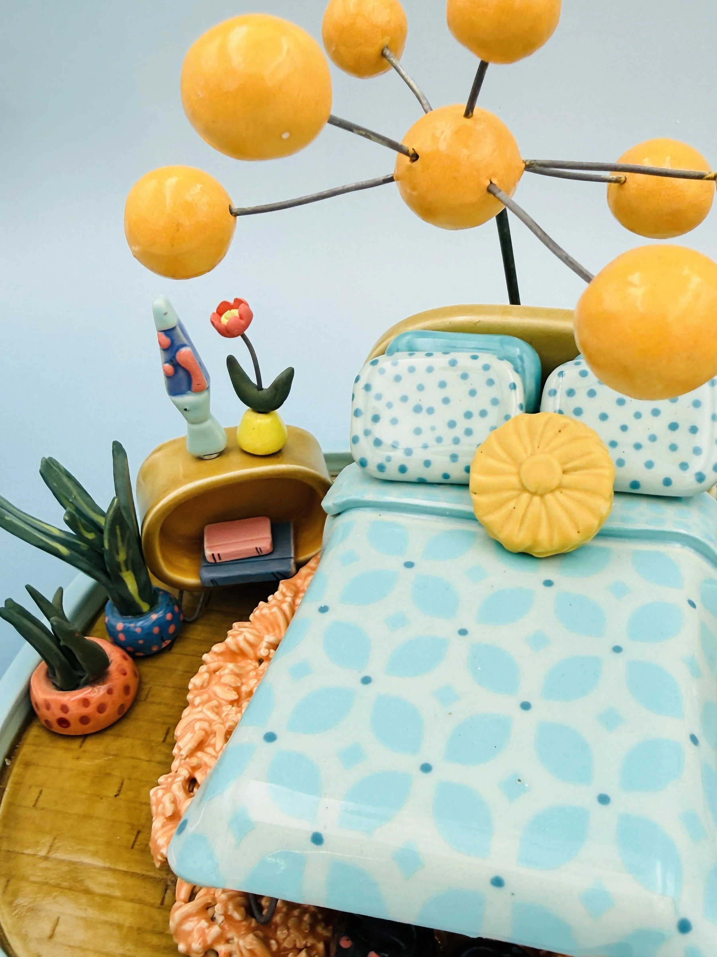 ceramic miniature, mid-century, modern inspired bedroom with bed, globe, lamps, shag, rug, potted plants, lava lamp, two kitties curled up under the bed