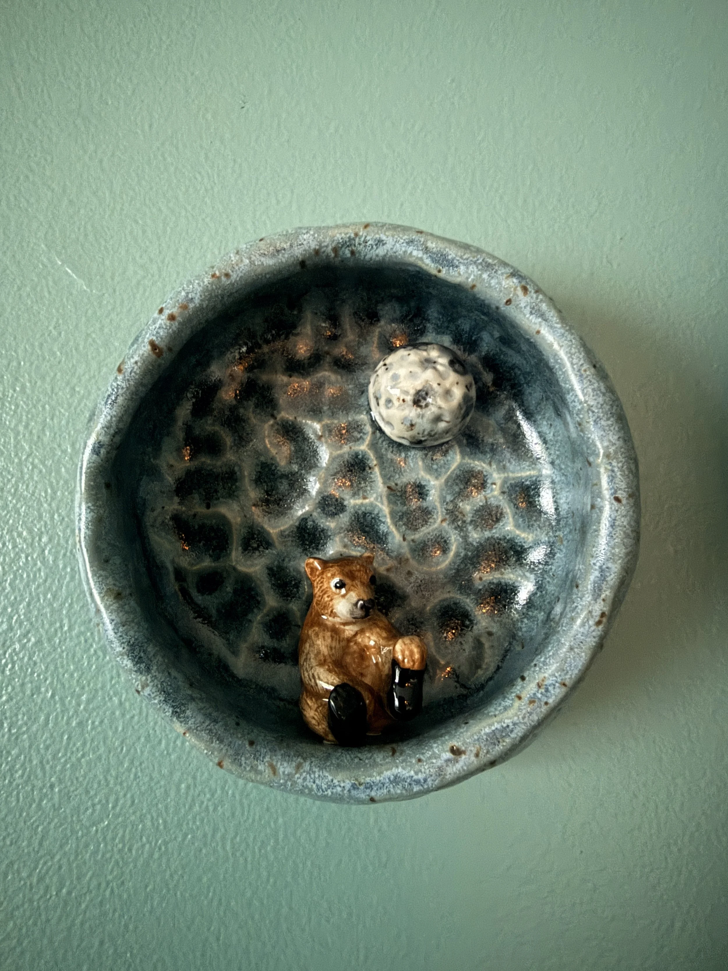  round ceramic wall, shrine with tiny white moon and a ceramic bear inside it