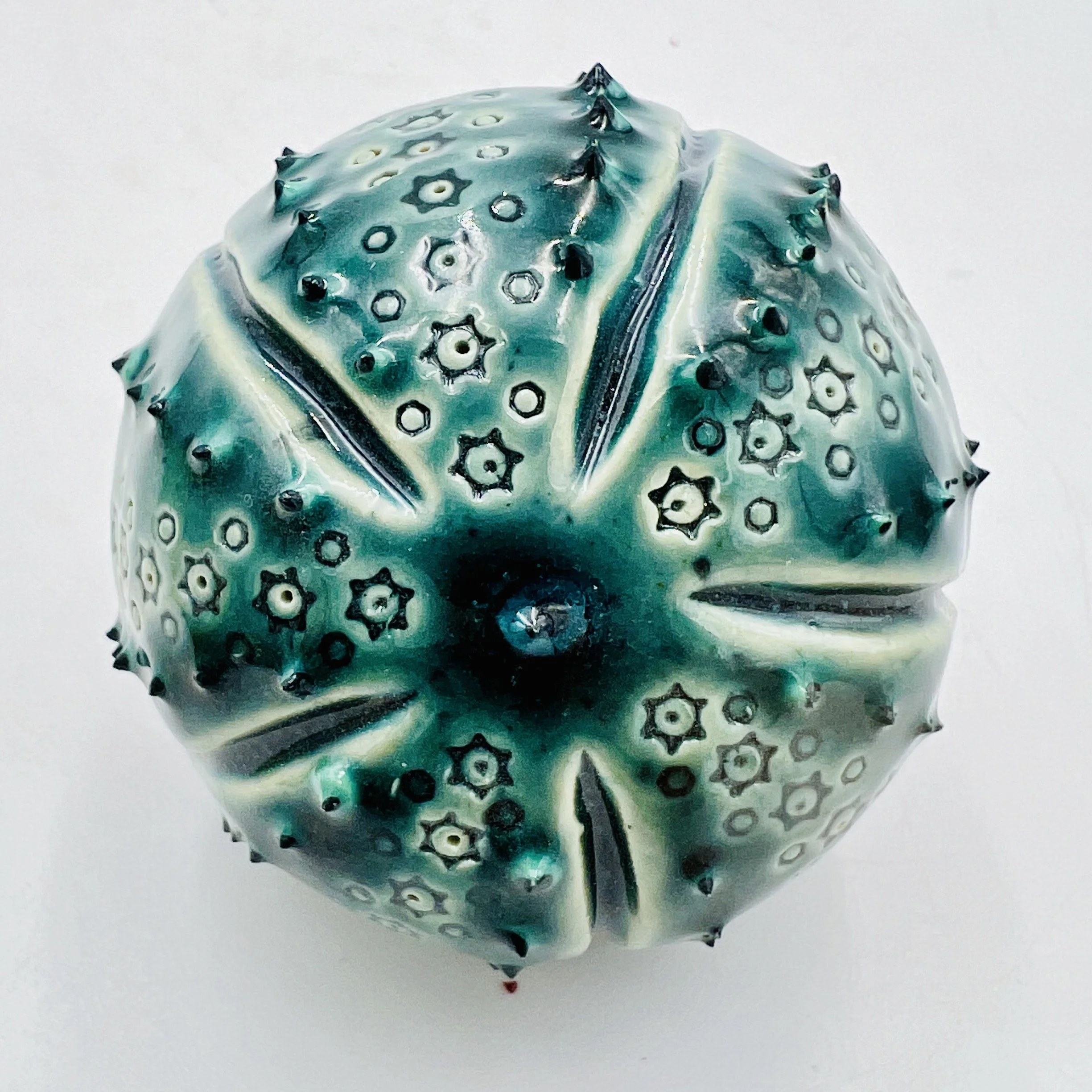 An intricately decorated ceramic sea urchin