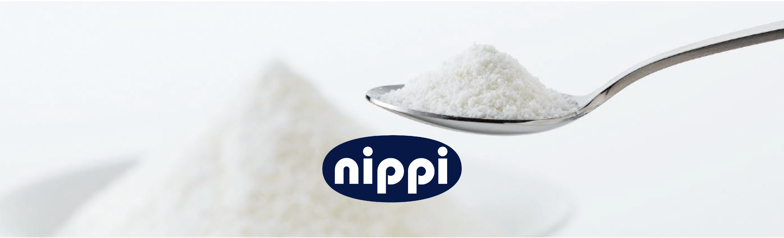A close-up of a spoon filled with white powder, with some powder falling off the spoon, and the word 'nipi' in a navy blue oval shape underneath.