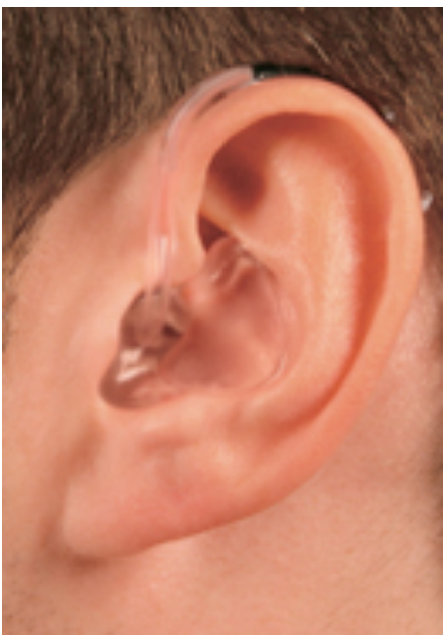 Close-up of a human ear with a hearing aid.